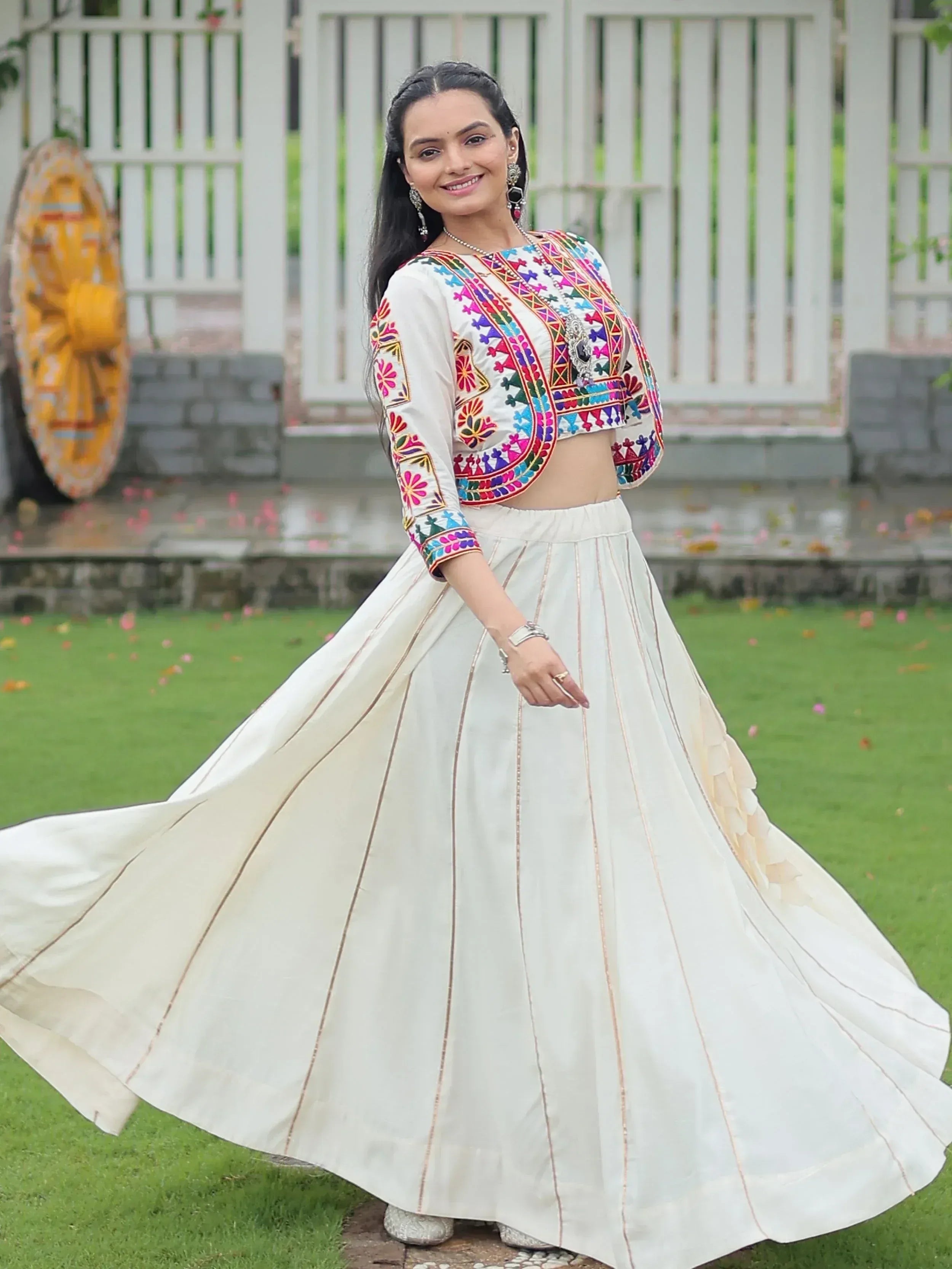 White ethnic lehenga choli with colorful embroidery, perfect for Indian festive wear and designer occasions.