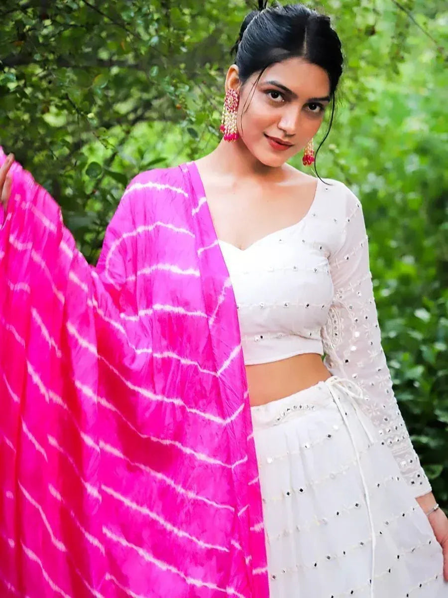 White embroidered lehenga choli with pink tie-dye dupatta, perfect for Indian ethnic wear occasions