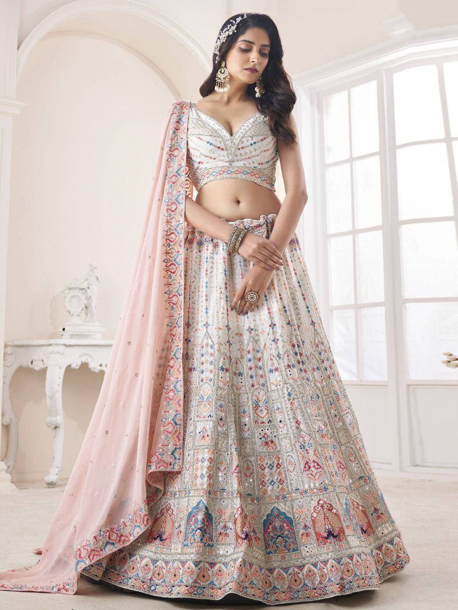 Elegant white lehenga choli with colorful embroidery and pink dupatta, perfect for Indian weddings and festive occasions.