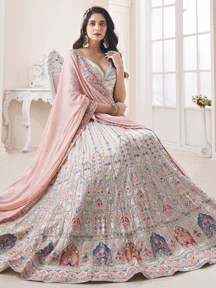 Elegant designer lehenga choli with intricate embroidery and pink dupatta, perfect for Indian weddings and festive occasions