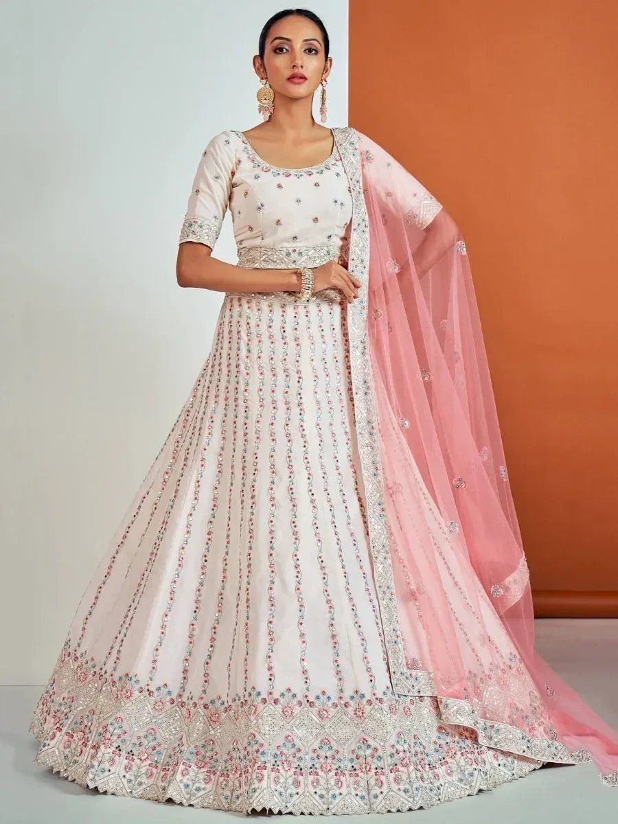 Elegant white lehenga choli with floral embroidery and pink dupatta, perfect for Indian ethnic occasions.