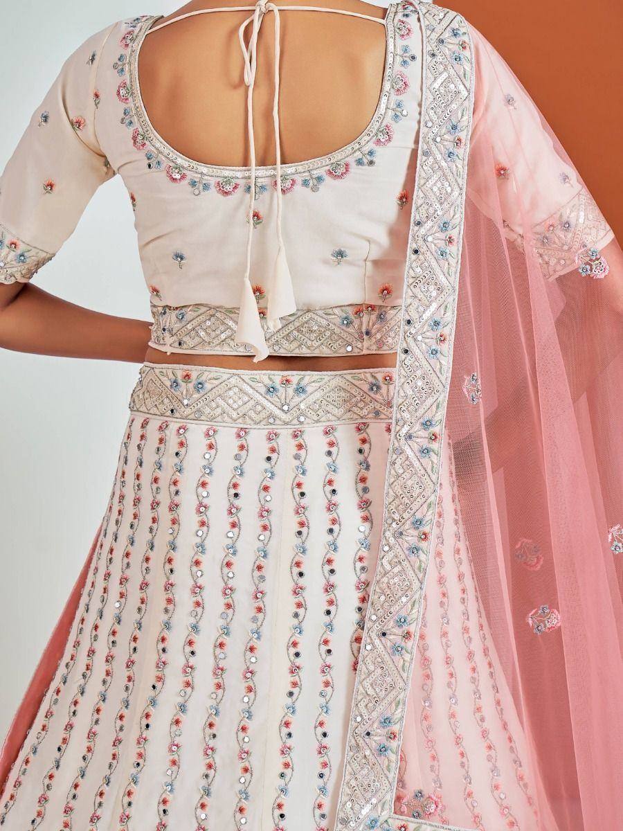 Elegant cream lehenga choli with floral embroidery, sequins, and pink dupatta for Indian ethnic wear