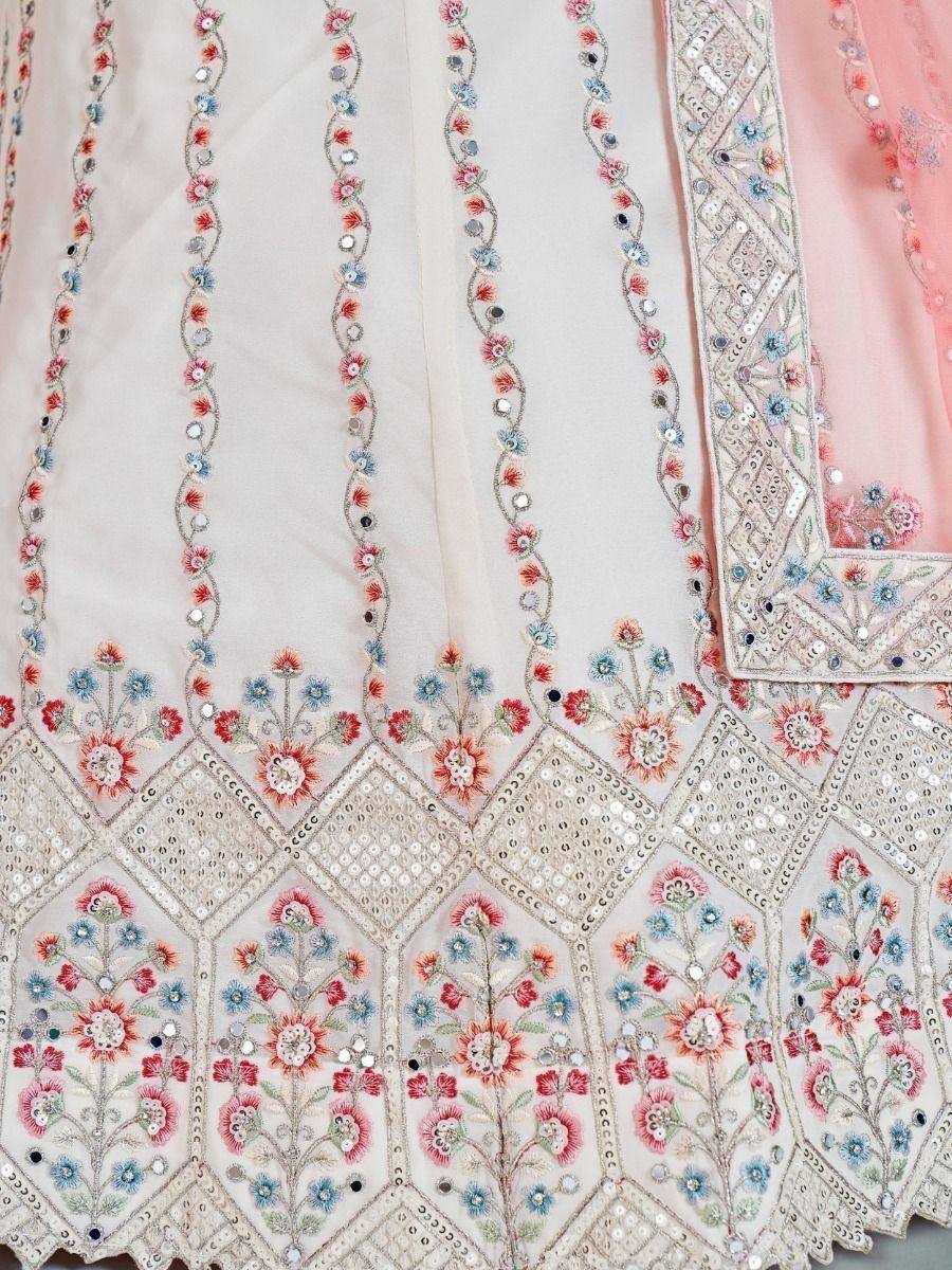 Elegant white lehenga with floral embroidery and mirror work, paired with pink dupatta for Indian ethnic wear.