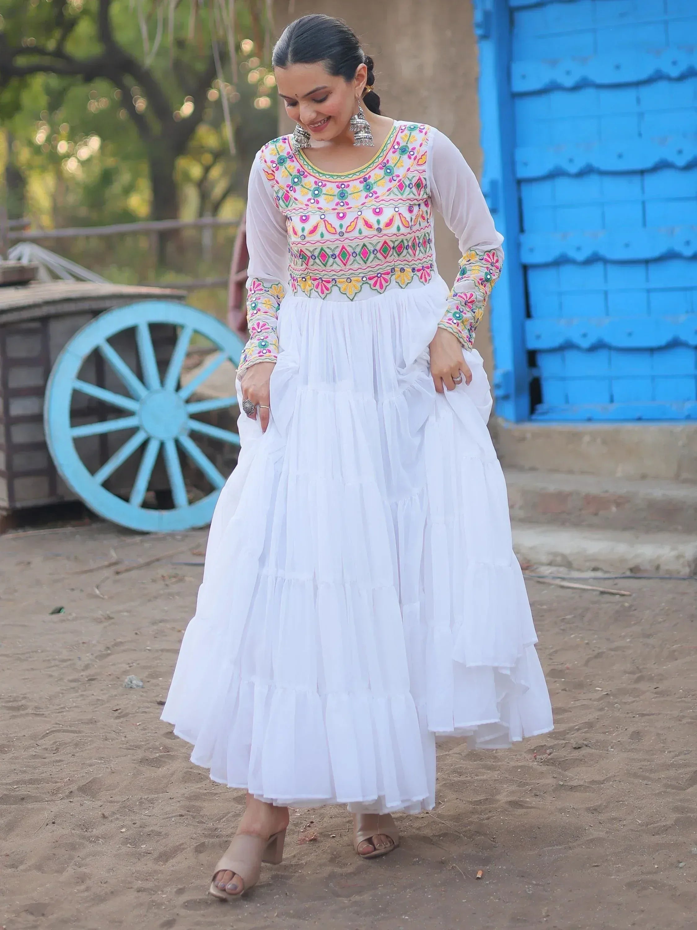 White embroidered ethnic gown with colorful floral patterns, perfect for Indian festive wear
