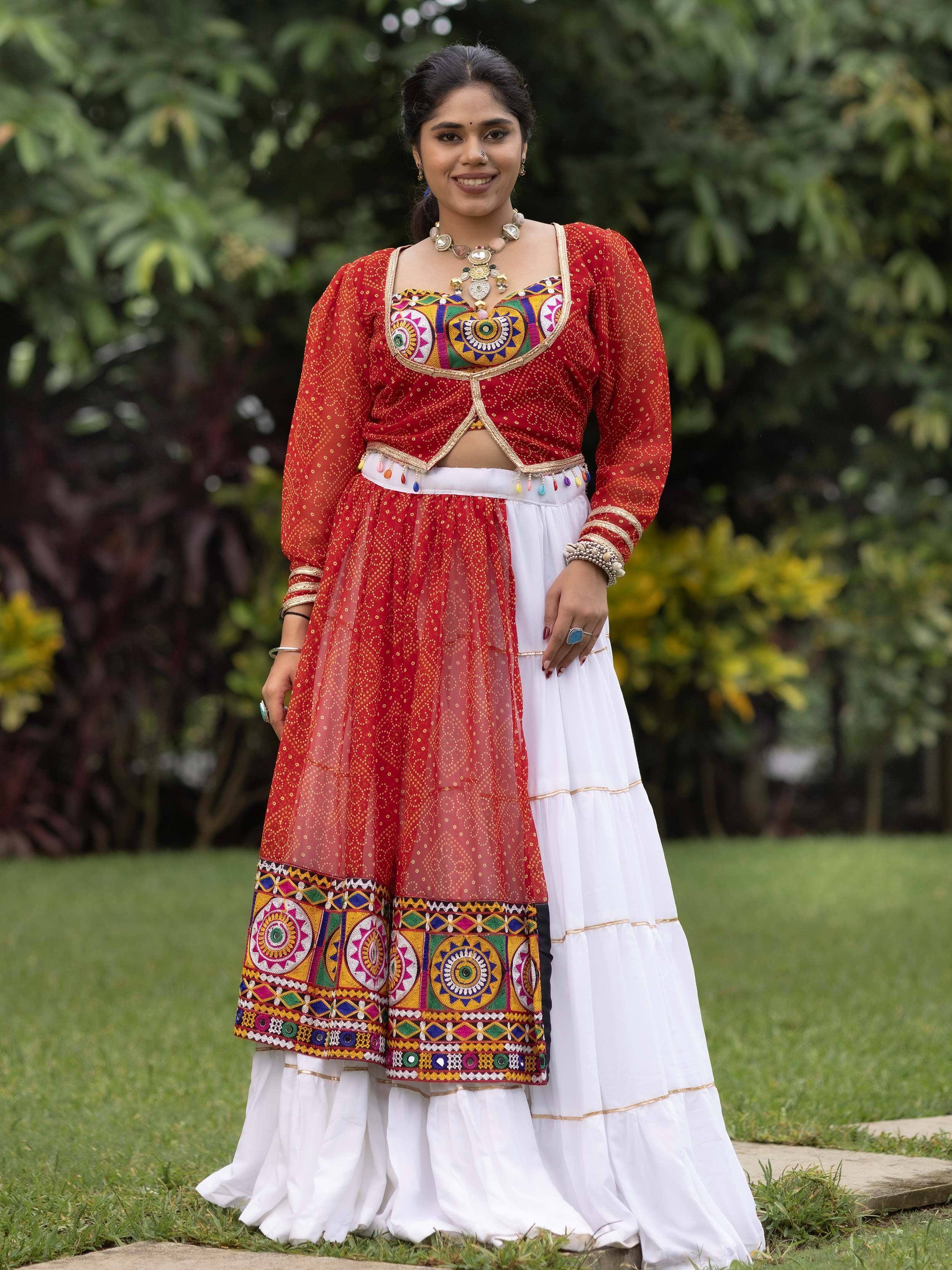 Woman in red and white embroidered ethnic lehenga choli with mirror work, perfect for Indian festivals and celebrations