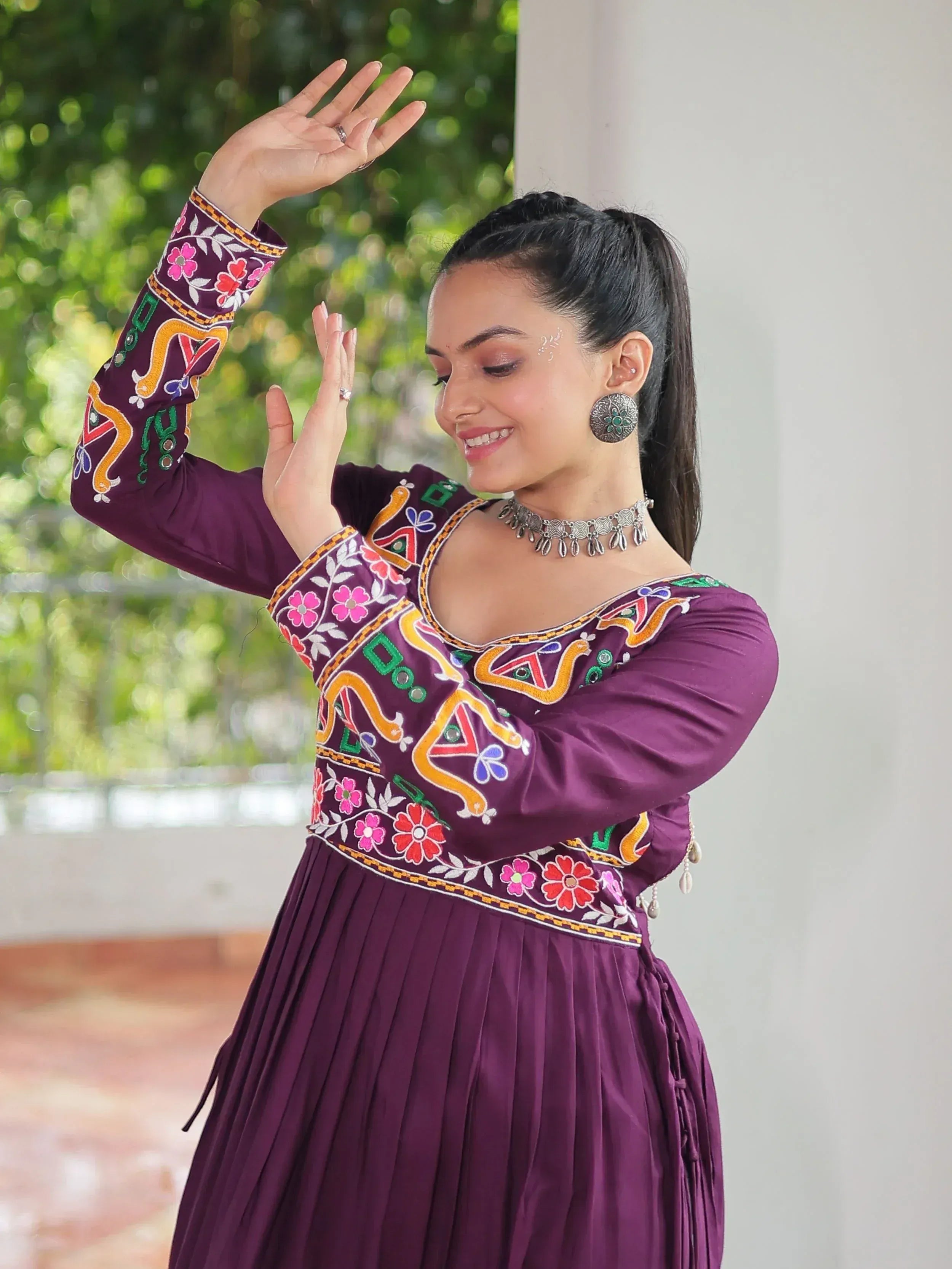 Purple embroidered ethnic gown with floral patterns, perfect for festive occasions and traditional celebrations.