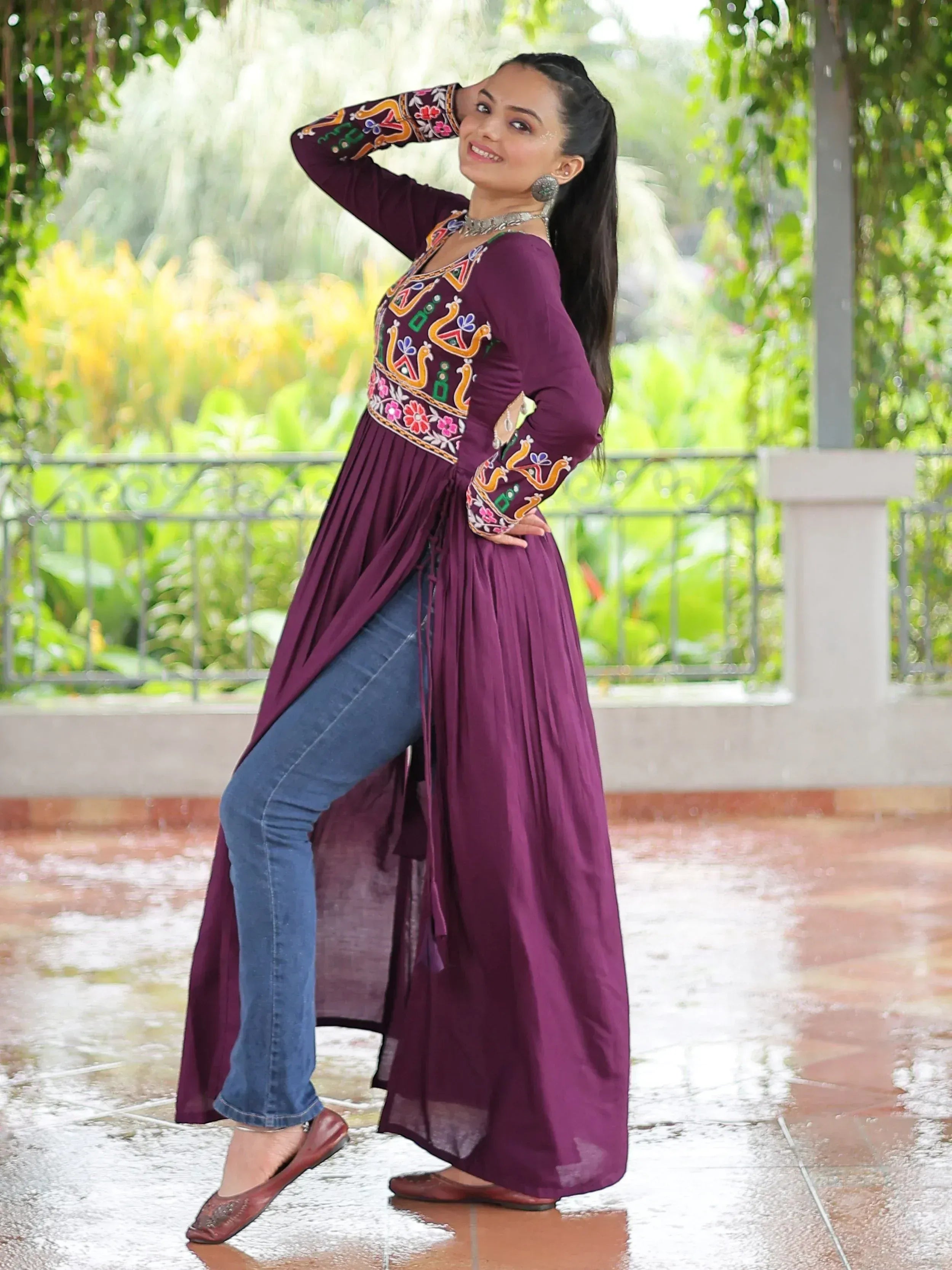 Woman in purple embroidered ethnic kurta with jeans, styled for festive occasions