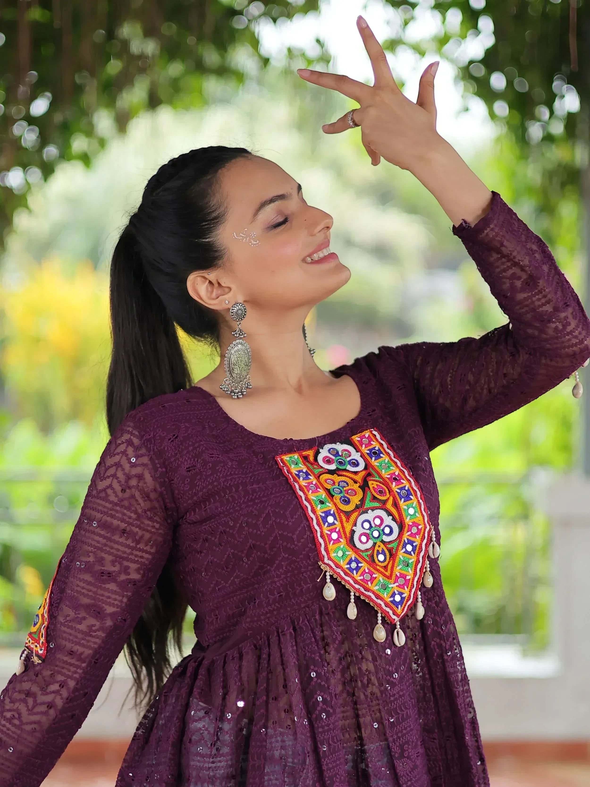 Woman in purple ethnic gown with colorful mirror work, perfect for Indian festive occasions