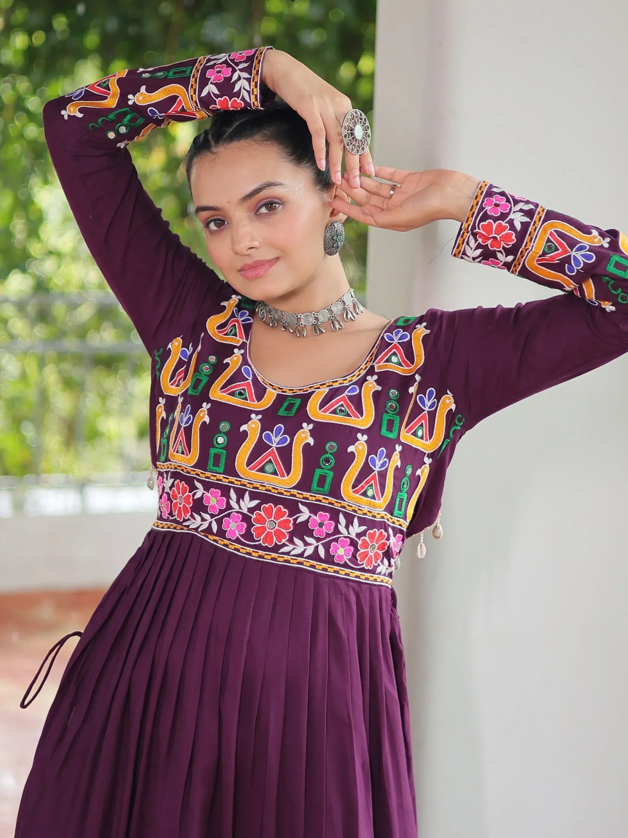 Purple embroidered ethnic gown with floral and peacock motifs, perfect for Indian occasions.