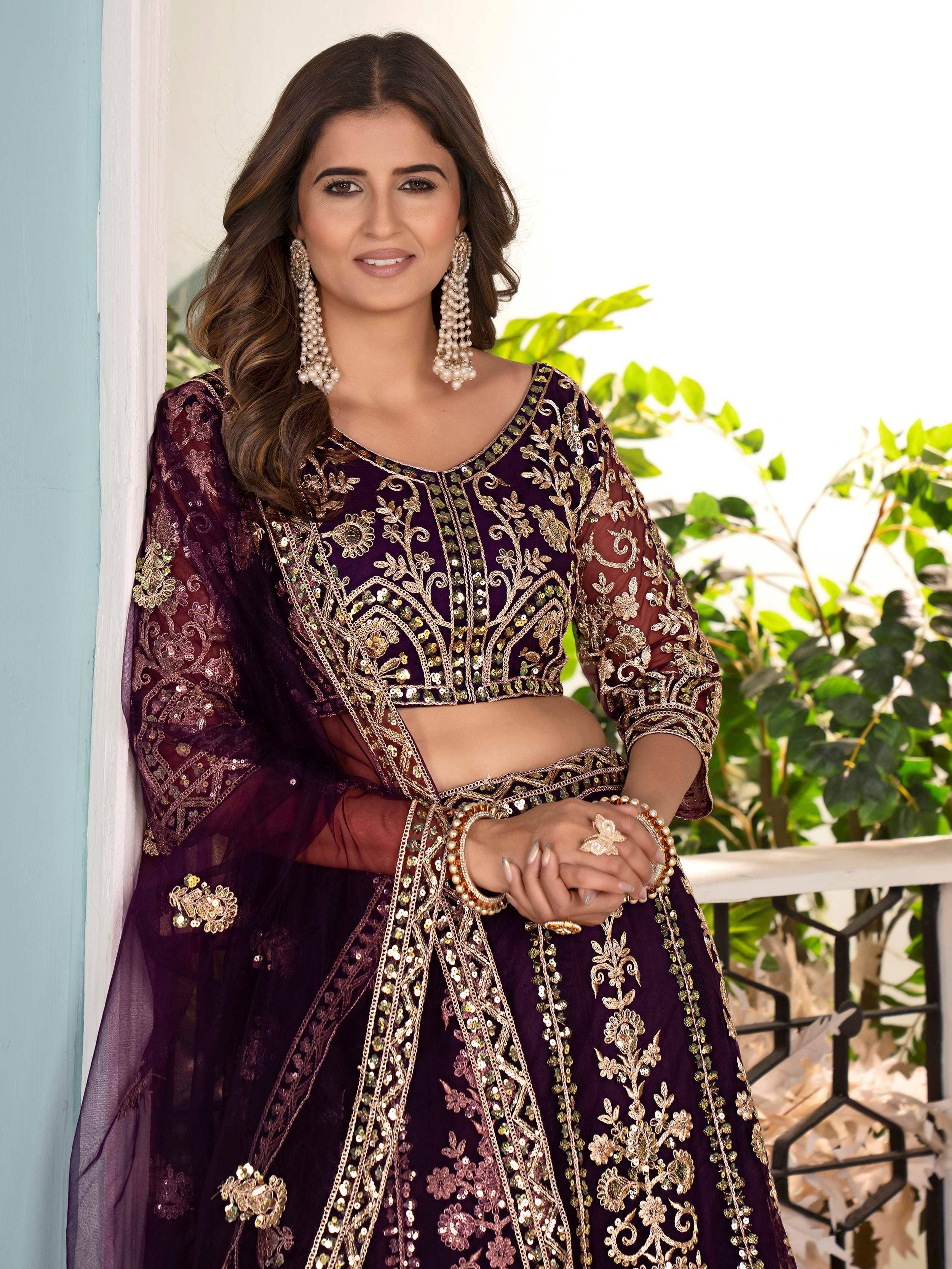 Elegant purple designer lehenga choli with gold embroidery and sequins, perfect for Indian ethnic wear.