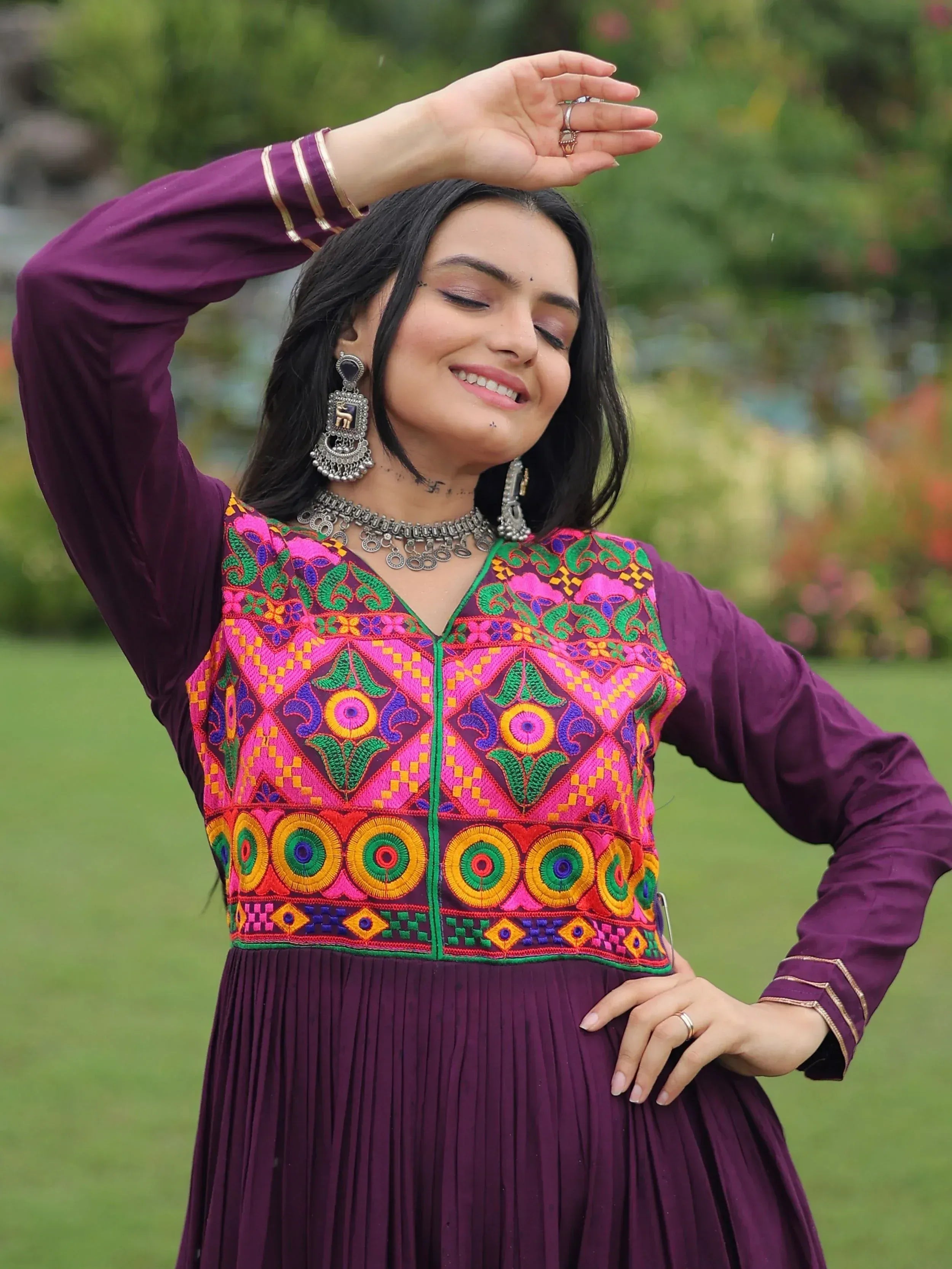 Woman in purple ethnic gown with vibrant embroidery, perfect for Indian festive occasions