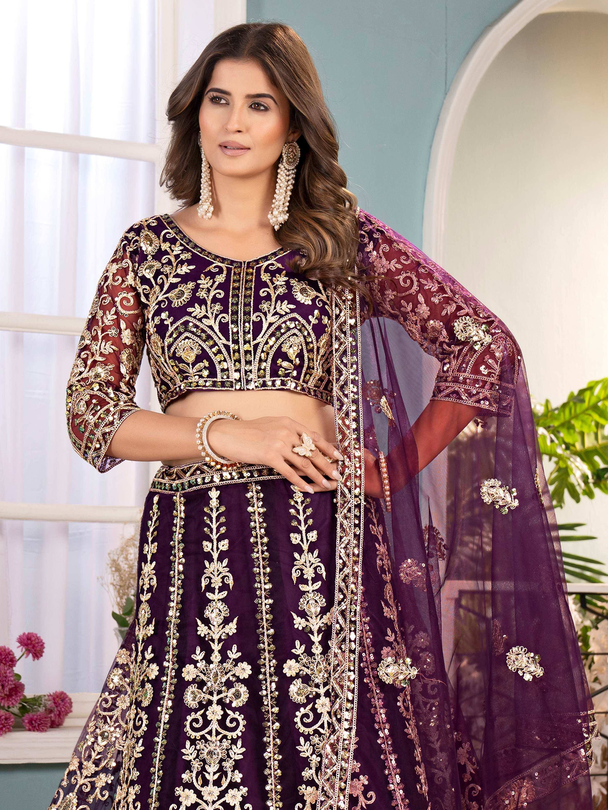 Purple embroidered lehenga choli with gold floral work, sheer dupatta, and statement jewelry for Indian ethnic wear