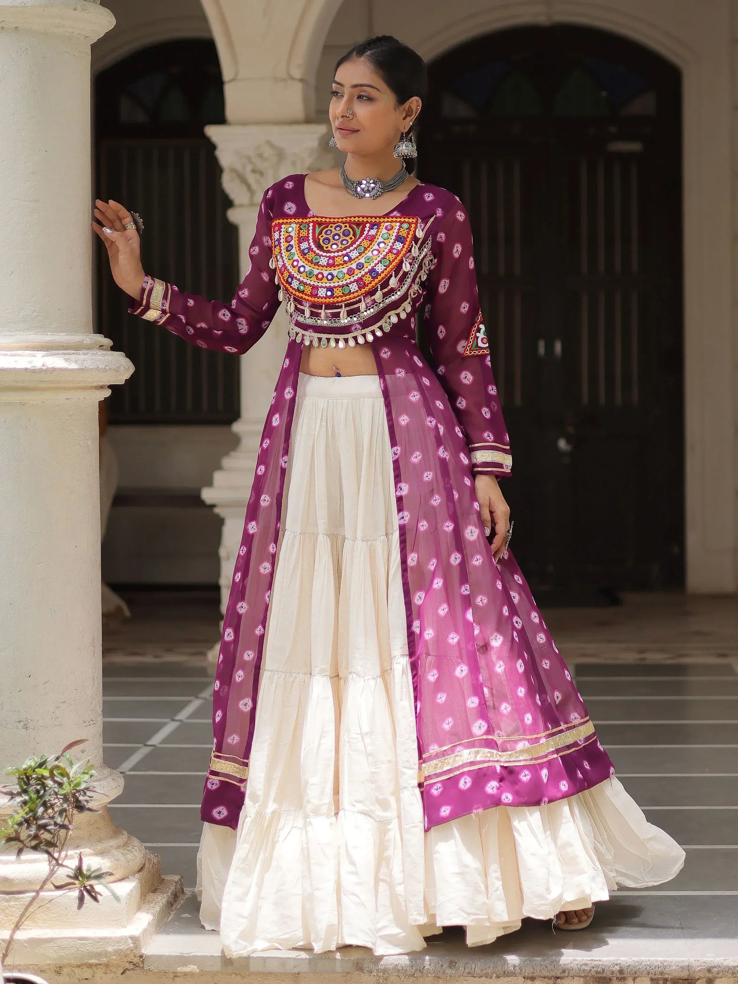 Purple and cream ethnic lehenga choli with mirror work, perfect for Indian weddings or festive occasions.