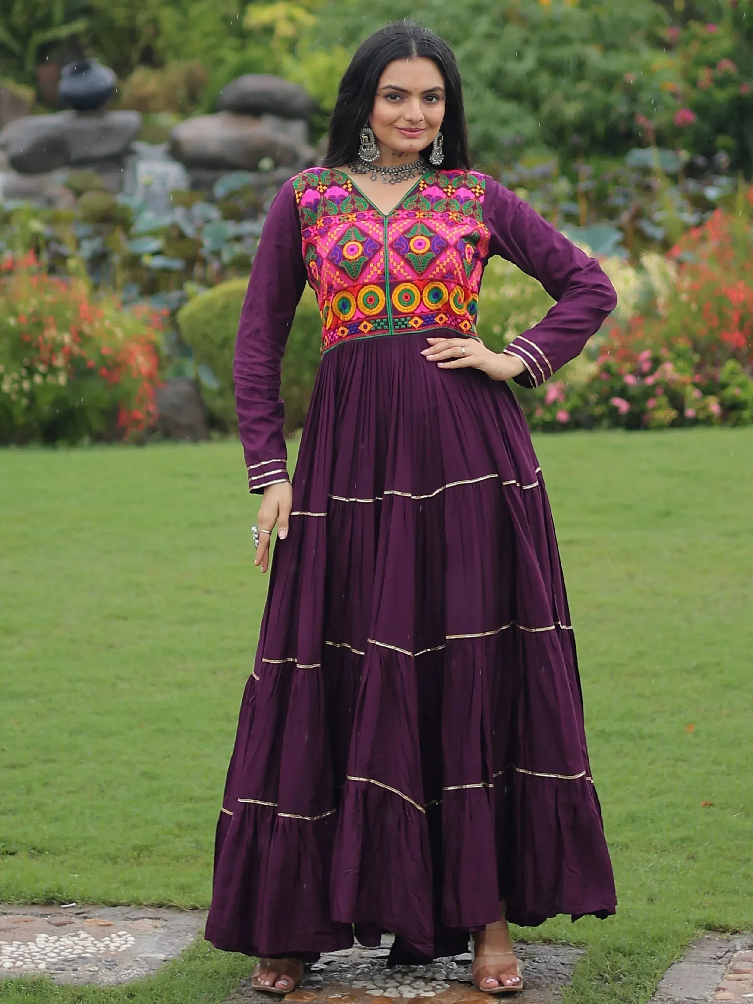 Purple ethnic gown with vibrant embroidered bodice, perfect for Indian festive occasions