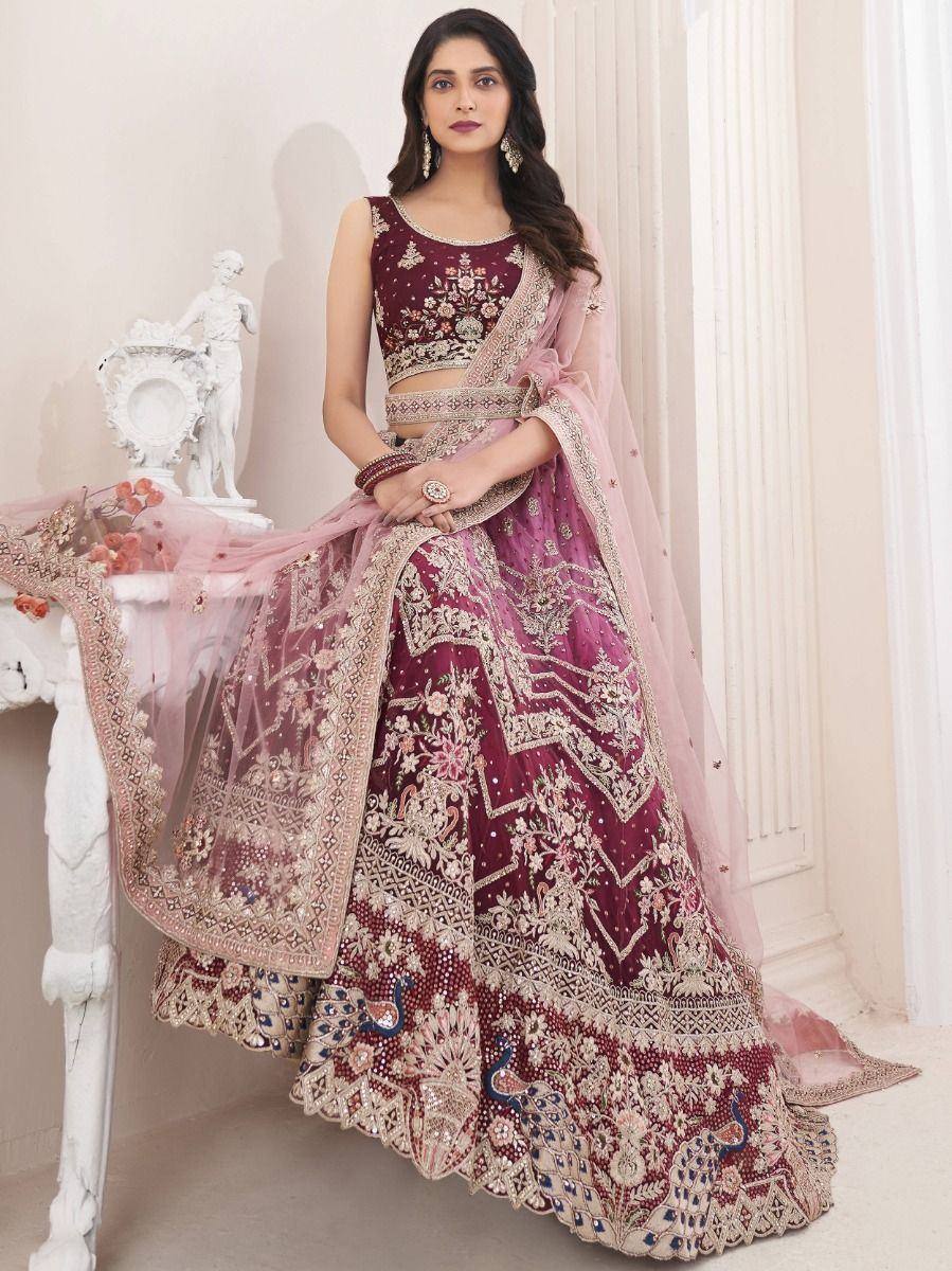 Maroon embroidered lehenga choli with peacock motifs, perfect for Indian weddings and festive occasions.