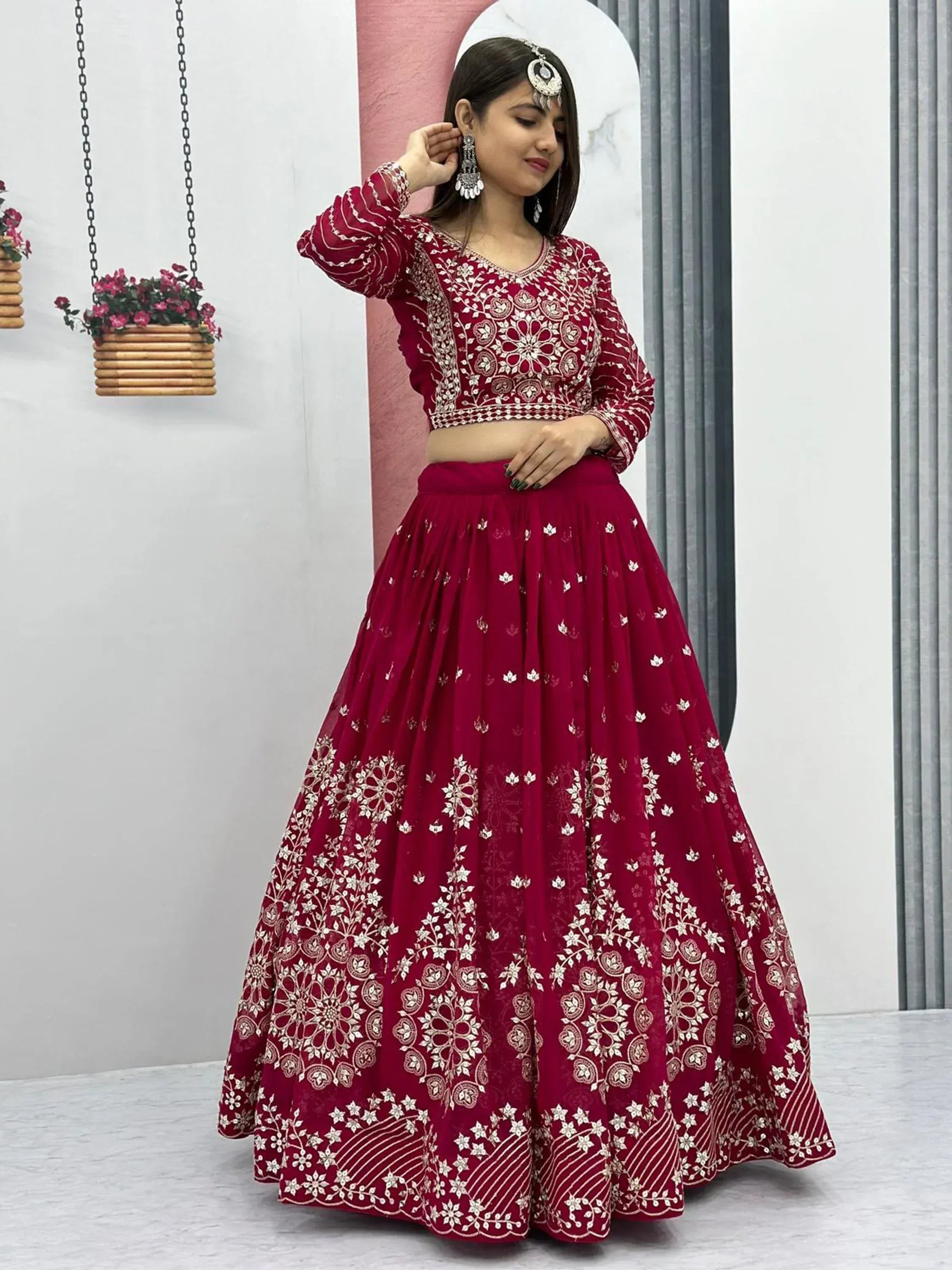 Maroon embroidered lehenga choli with floral motifs, perfect for Indian ethnic wear and festive occasions.