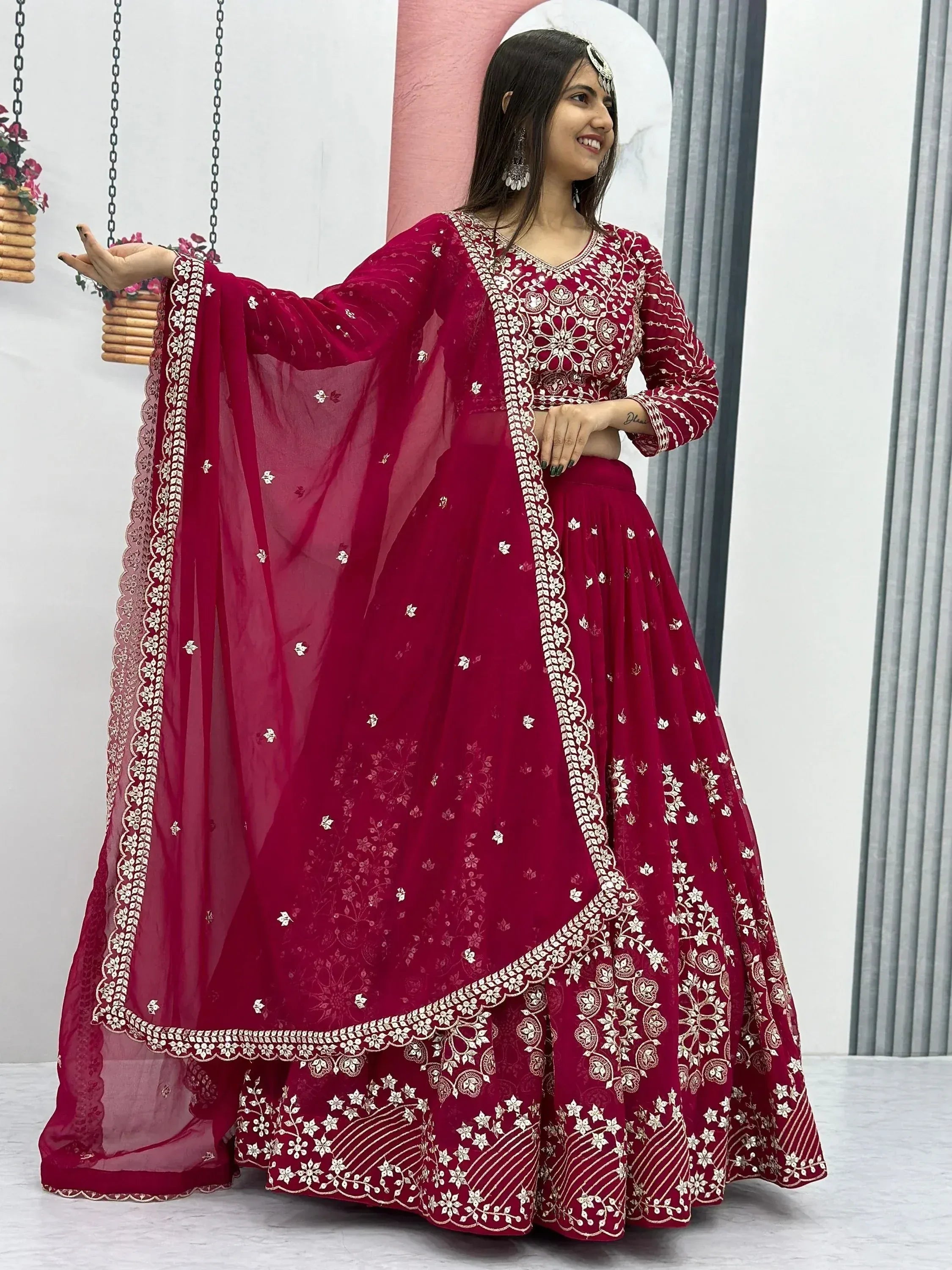 Woman in maroon embroidered lehenga choli with dupatta, Indian ethnic wear for weddings and festivals
