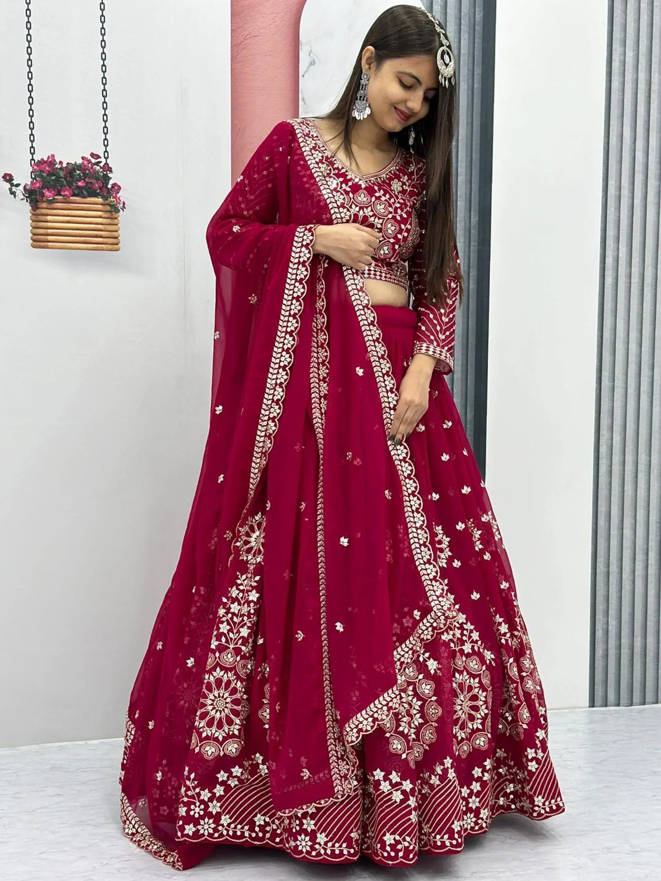 Maroon embroidered lehenga choli with floral motifs and sheer dupatta, perfect for Indian ethnic occasions