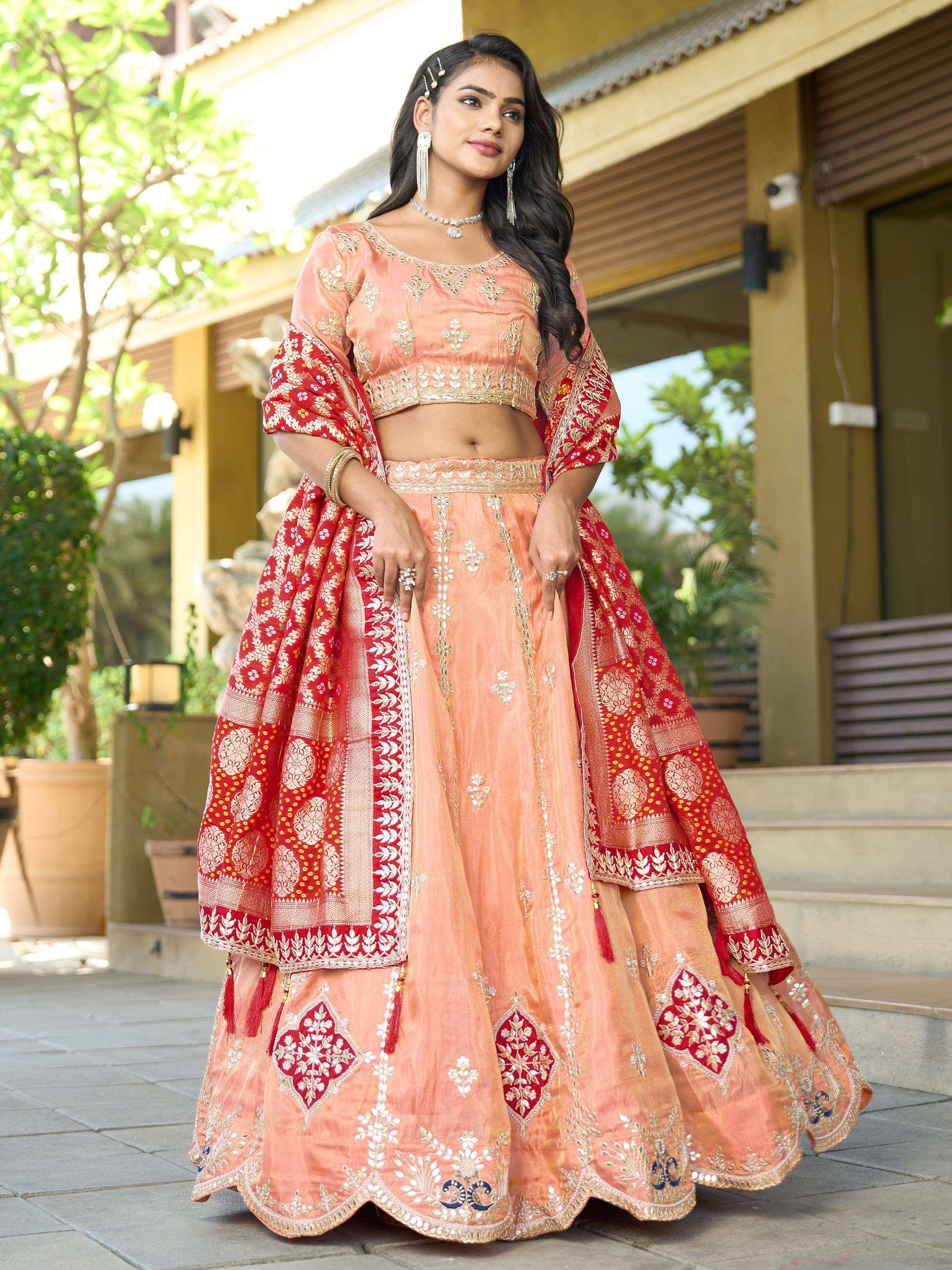 Elegant peach lehenga choli with red dupatta, perfect for Indian ethnic wear and festive occasions.