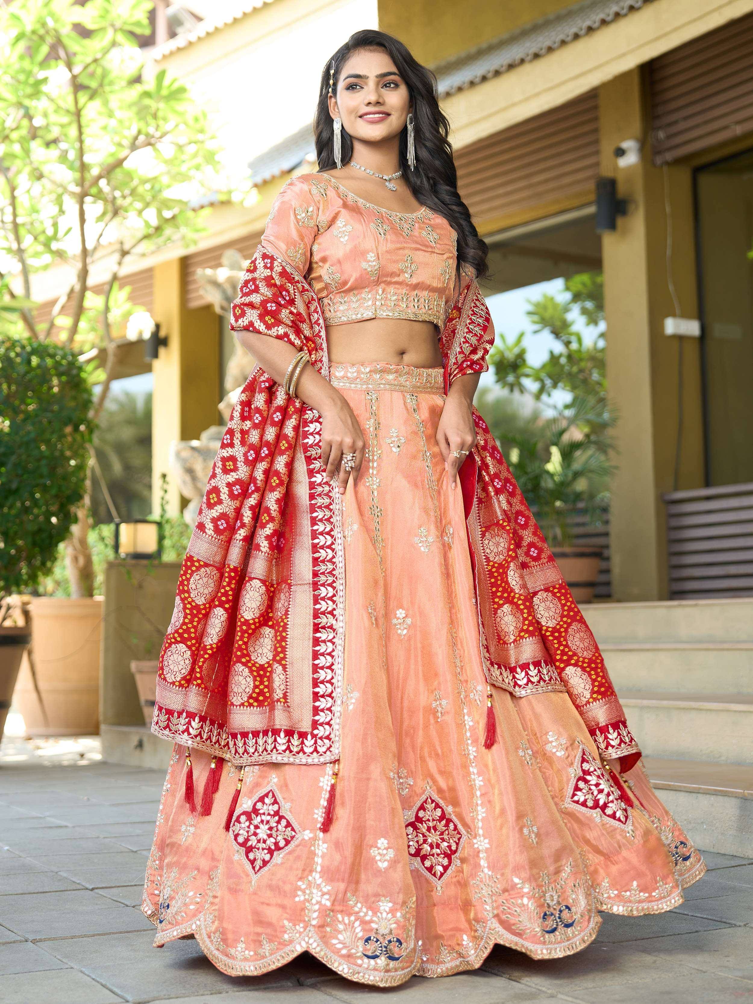 Elegant peach lehenga choli with red dupatta, perfect for Indian ethnic wear and festive occasions.