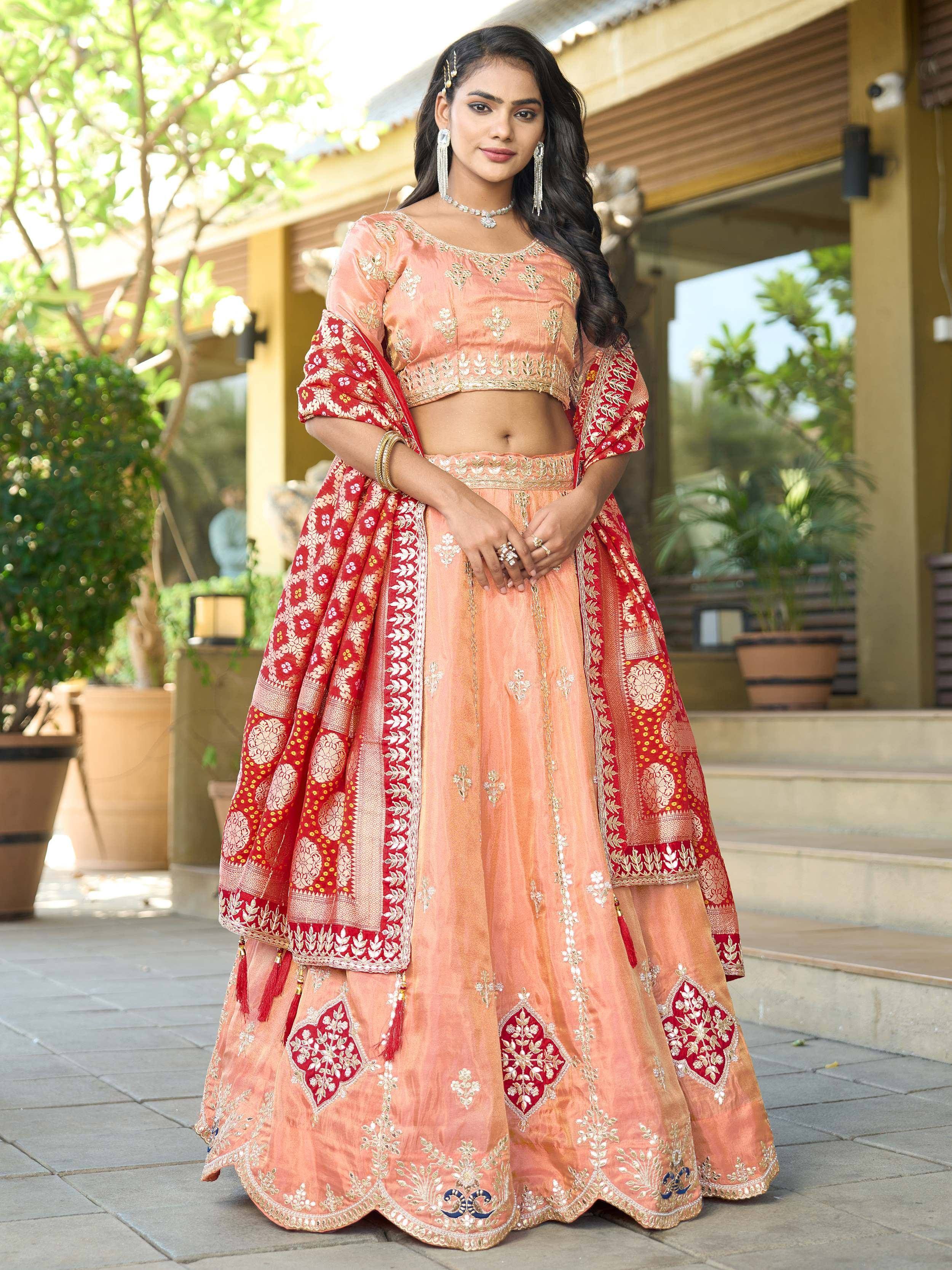 Peach and red embroidered lehenga choli with gold detailing, perfect for Indian ethnic wear