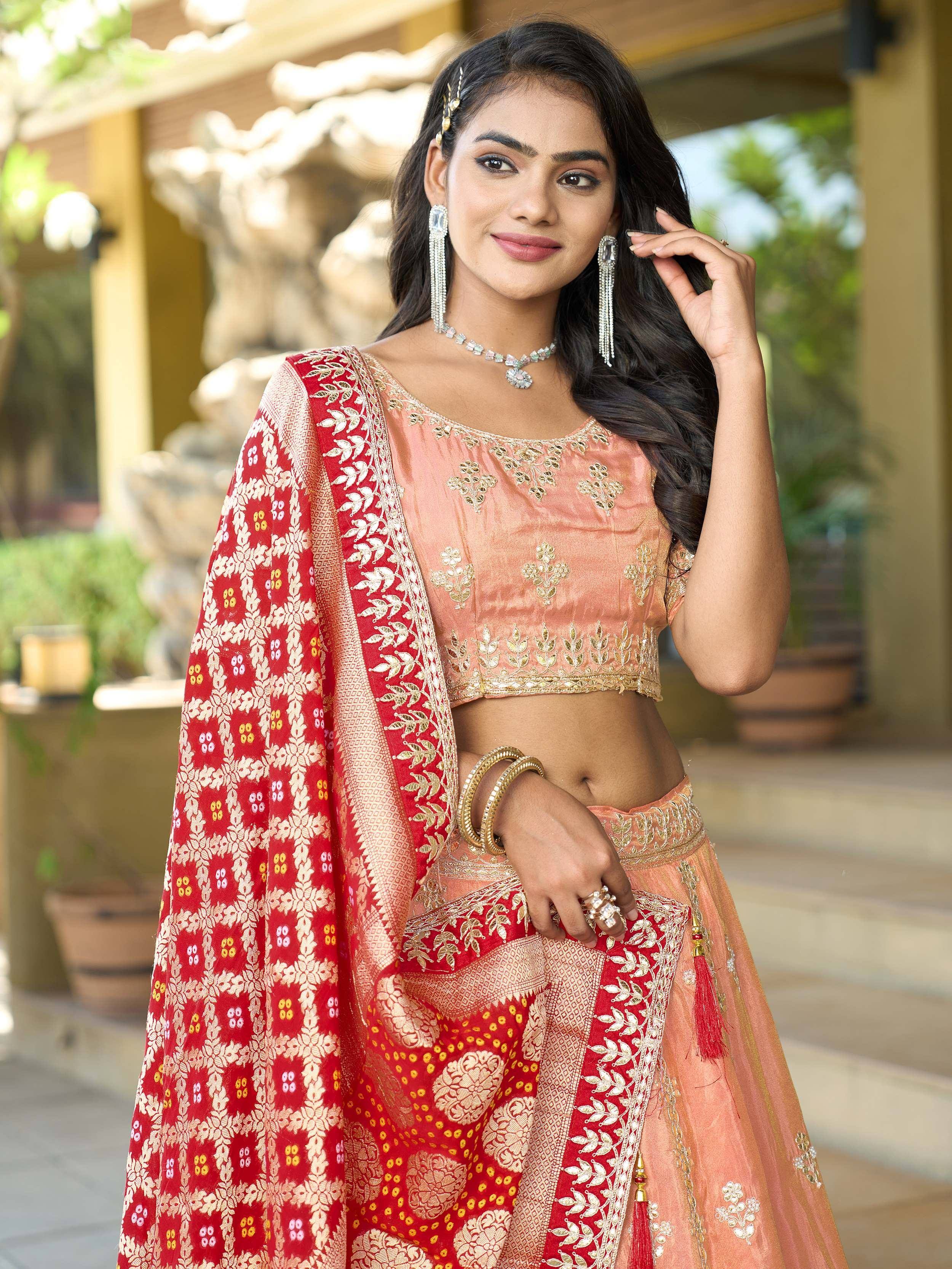 Elegant peach lehenga choli with red floral dupatta, perfect for Indian ethnic wear occasions