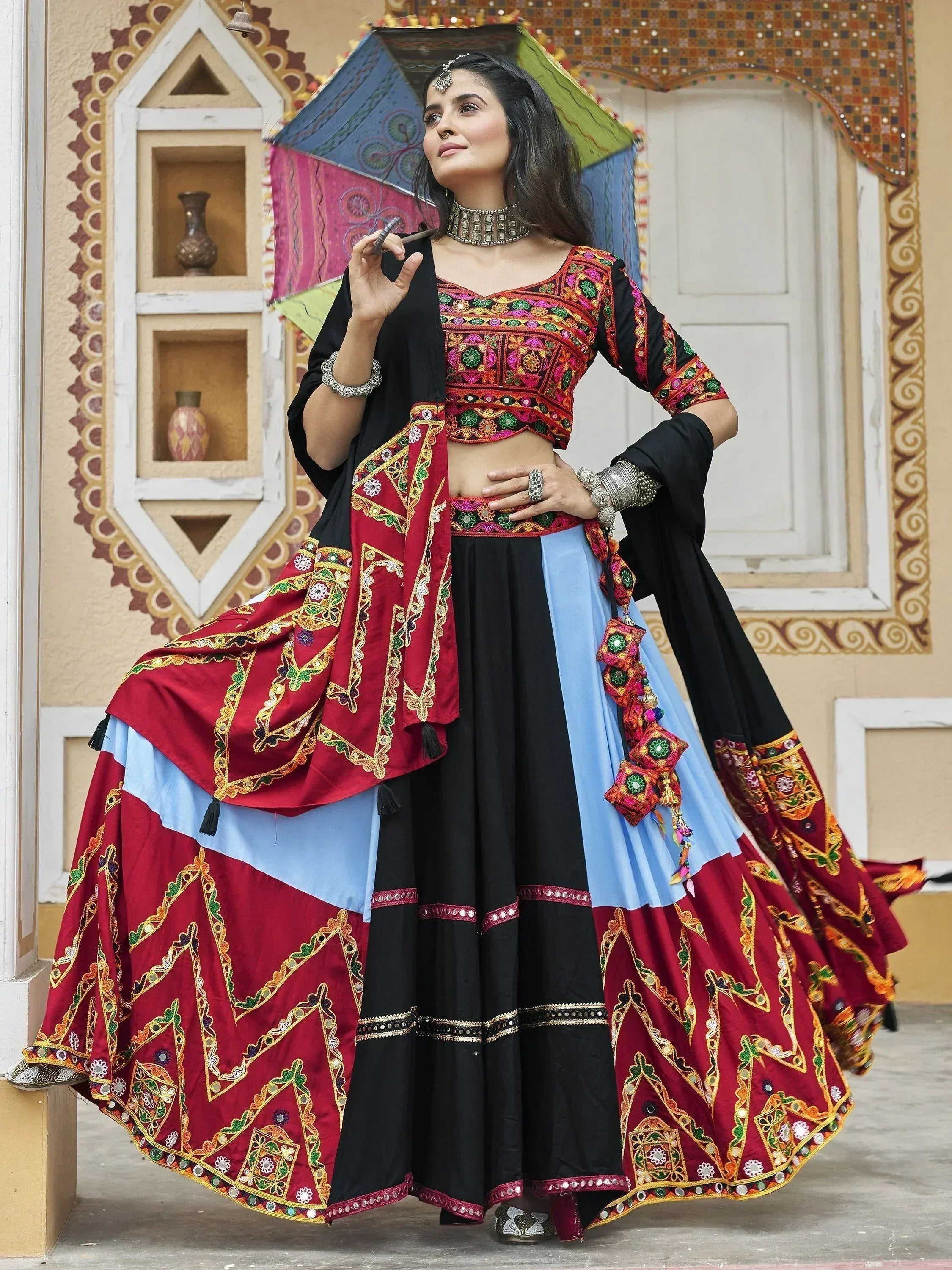 Woman in vibrant embroidered lehenga choli with mirror work, traditional Indian ethnic wear