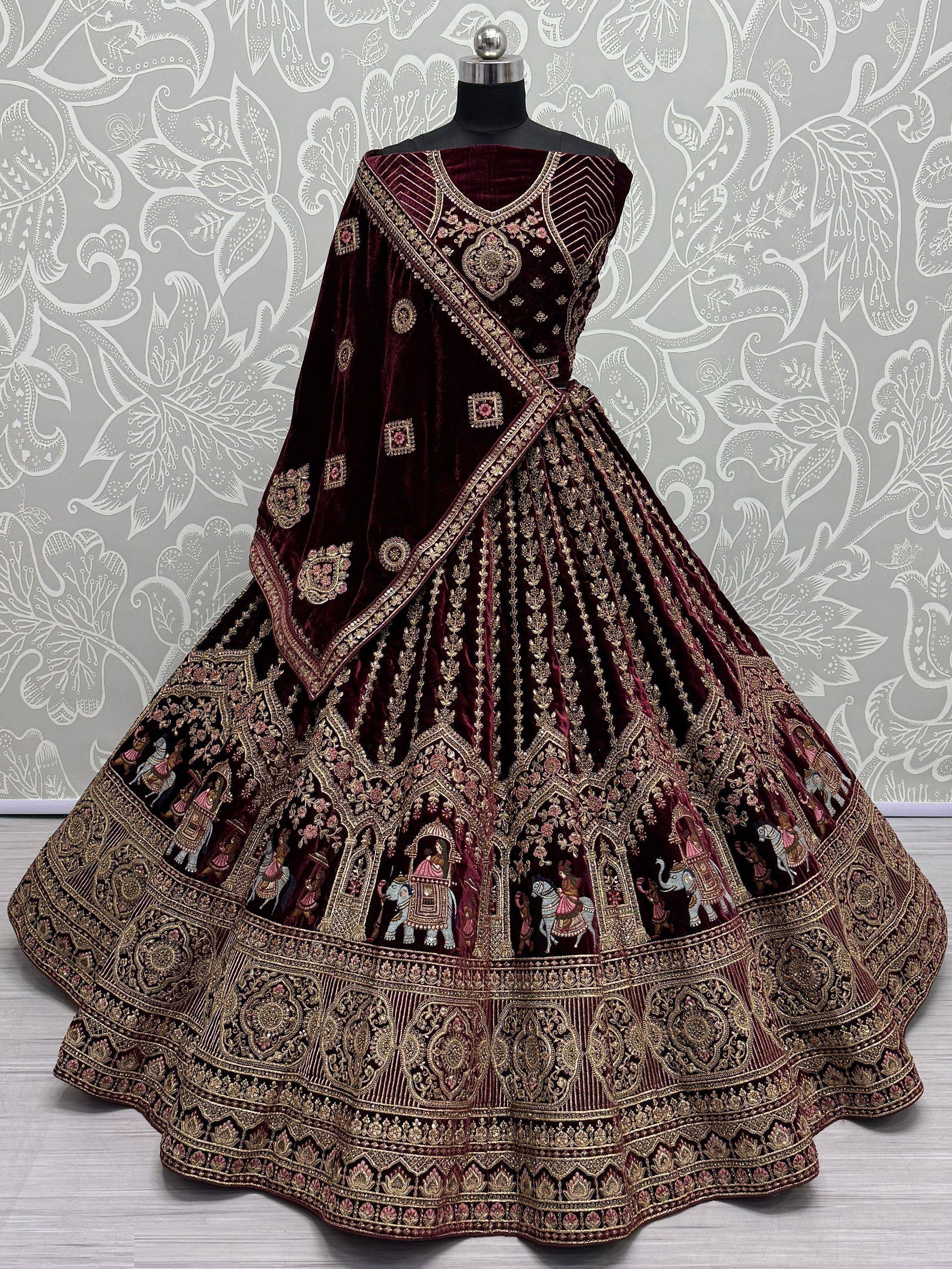 Maroon velvet lehenga choli with gold embroidery and elephant motifs, perfect for Indian ethnic wear.