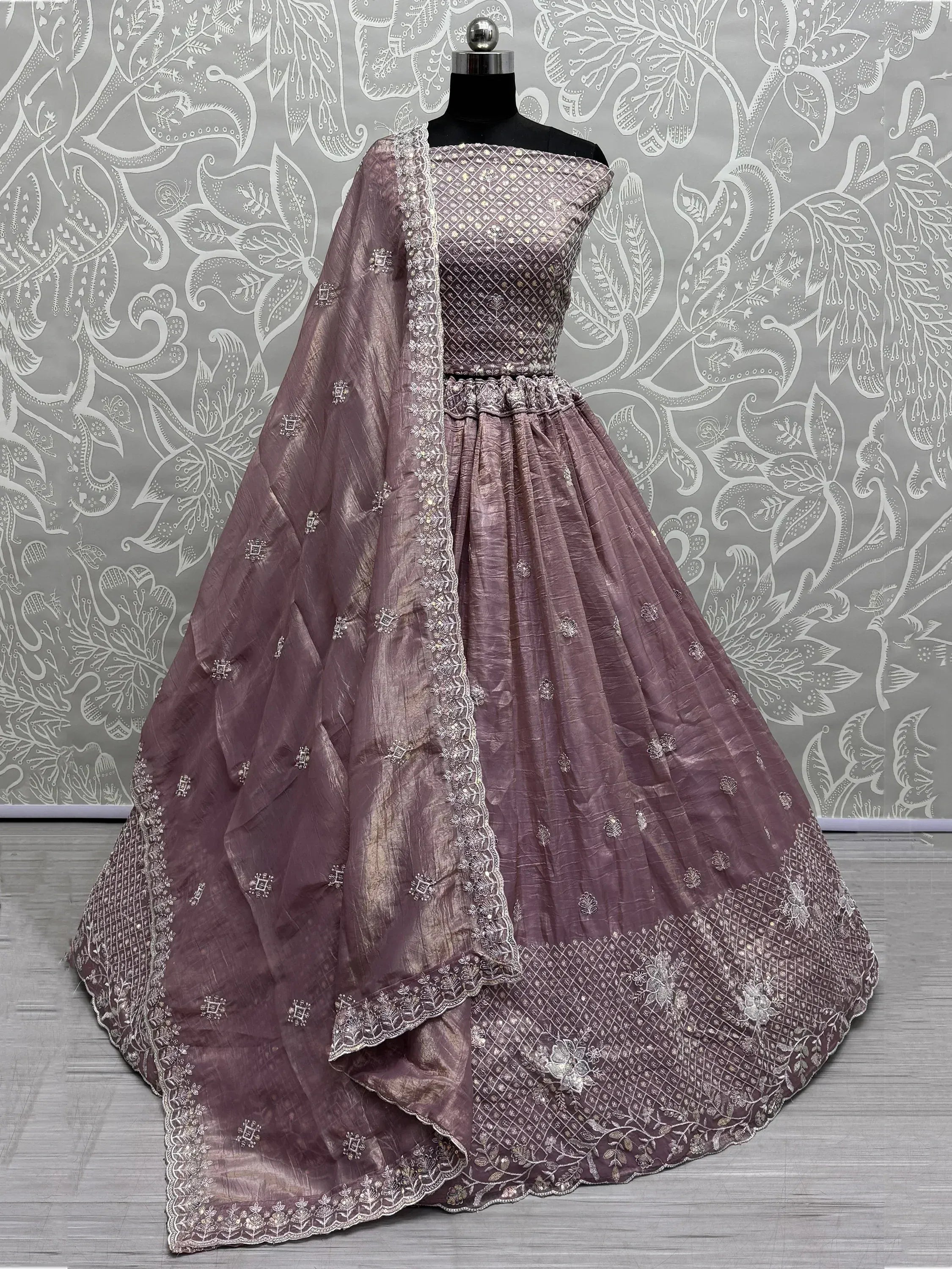Elegant mauve lehenga choli with intricate silver embroidery and matching dupatta, perfect for Indian ethnic occasions.