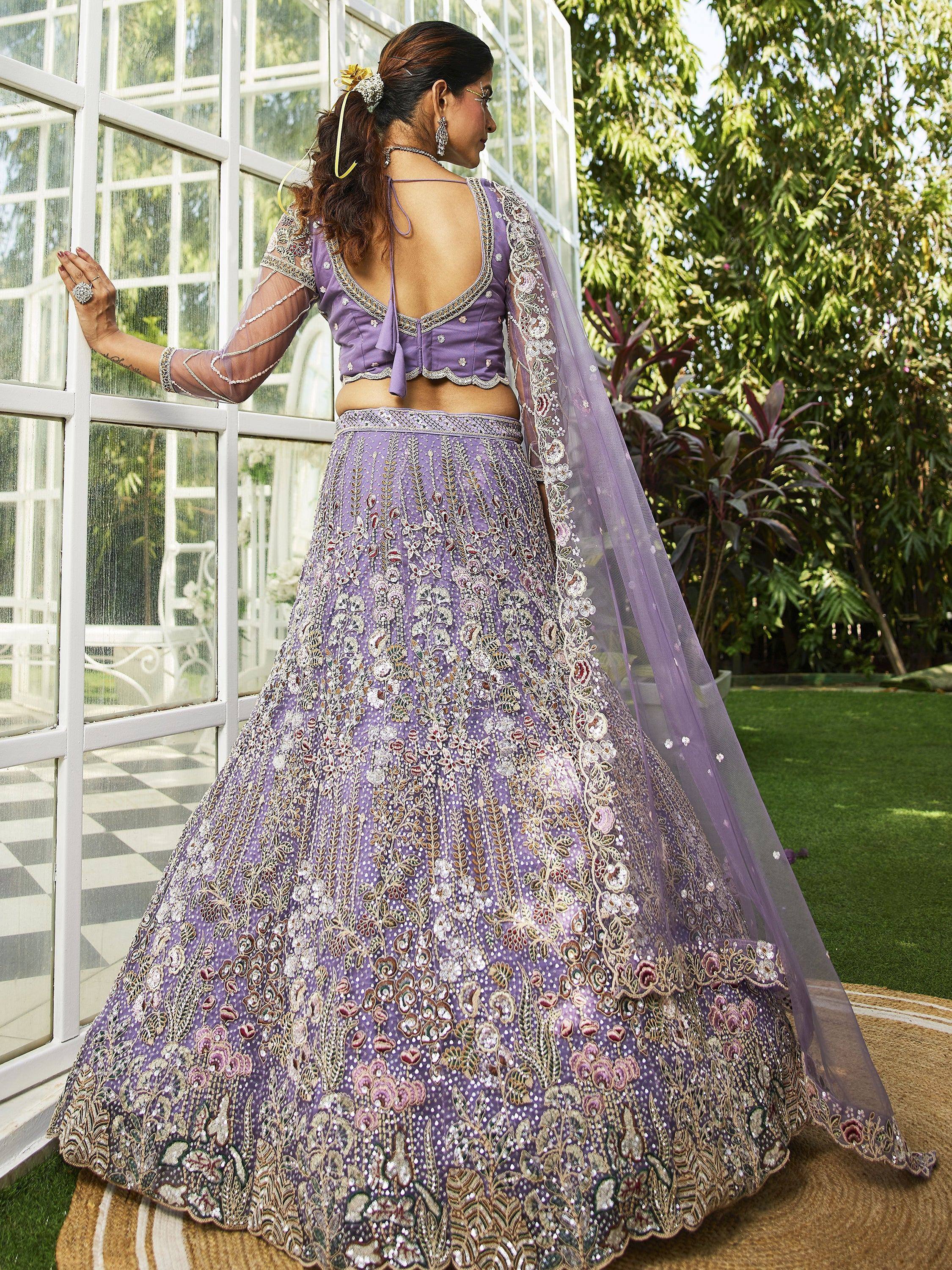 Purple embroidered lehenga choli with sheer sleeves and floral dupatta, perfect for Indian weddings and festive occasions.