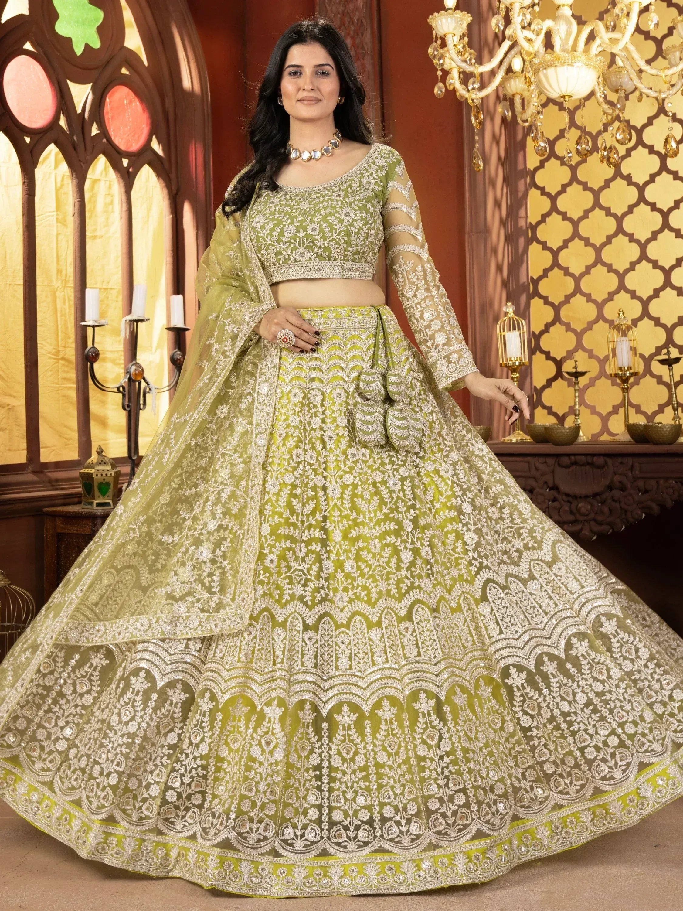 Elegant green designer lehenga choli with intricate white embroidery, perfect for weddings and festive occasions.
