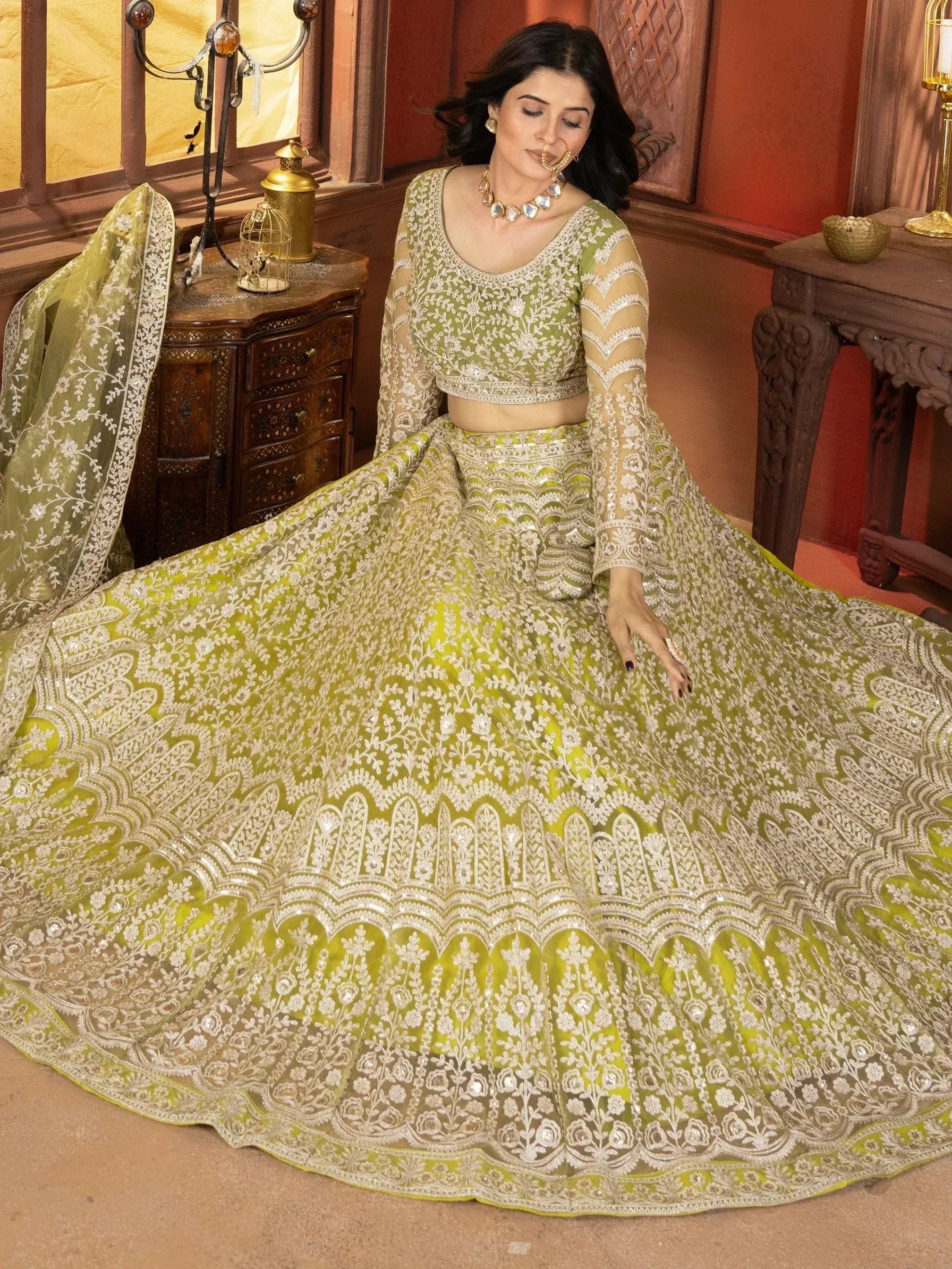 Elegant lime green lehenga choli with intricate white embroidery and sheer sleeves, perfect for Indian ethnic wear.
