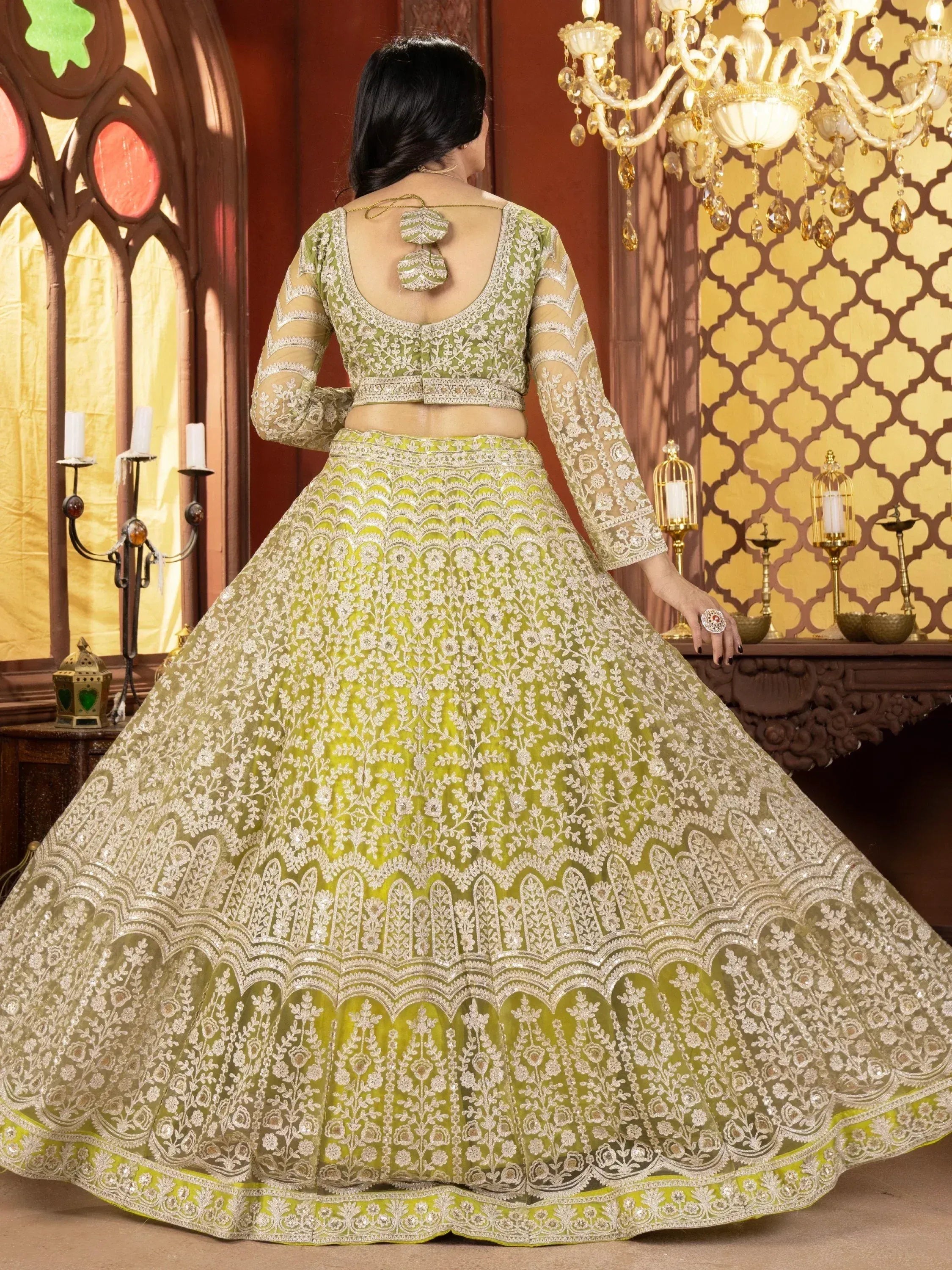 Elegant green lehenga choli with intricate white embroidery, perfect for Indian weddings and festive occasions.