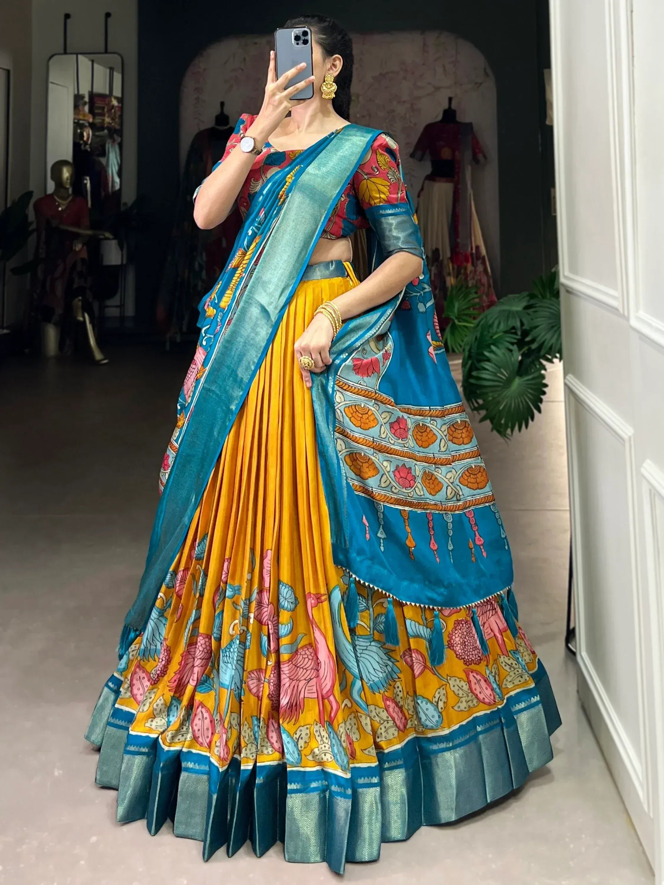 Vibrant yellow and blue printed lehenga choli with floral and bird motifs, perfect for Indian ethnic occasions