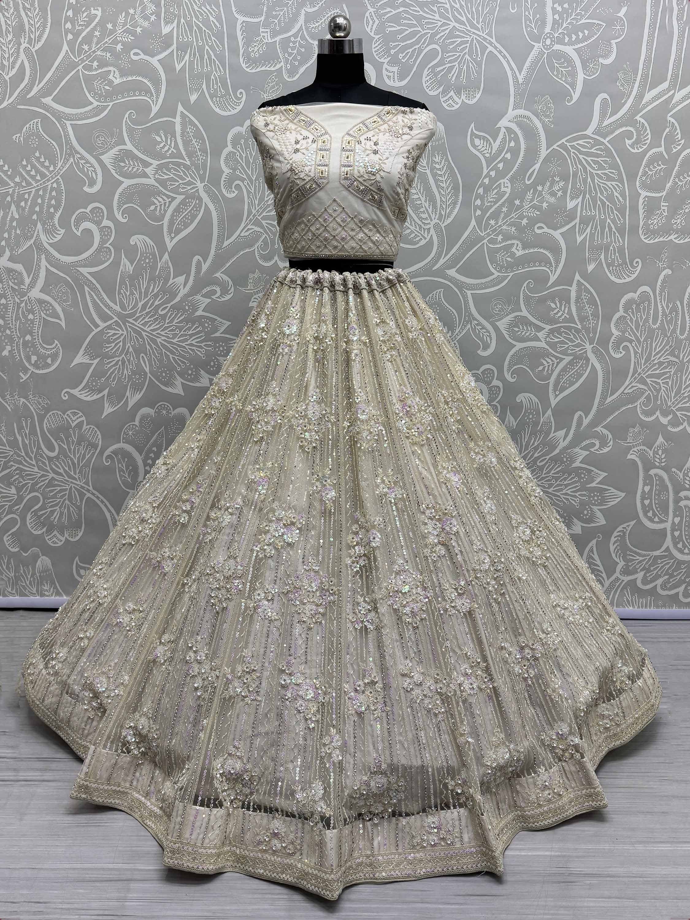 Ivory designer lehenga choli with heavy embroidery and sequins, perfect for weddings and festive occasions