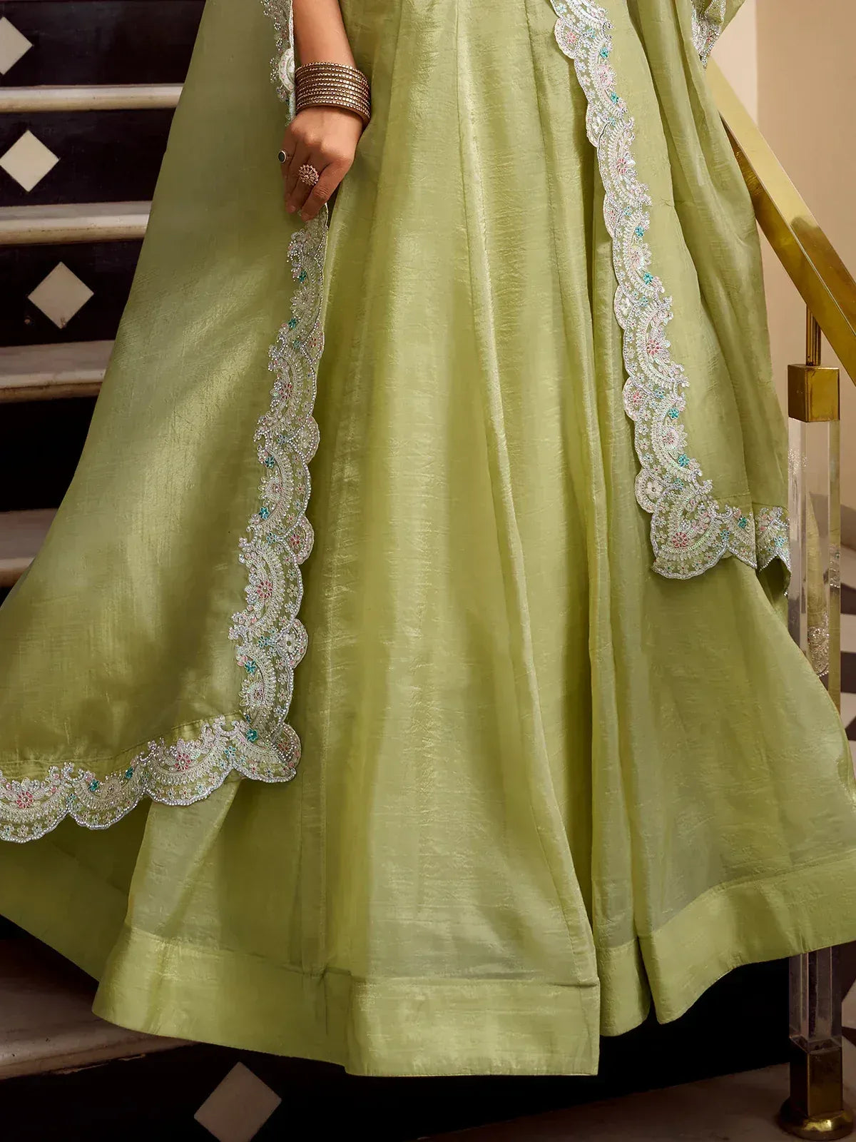 Light green ethnic gown with floral embroidery, perfect for Indian weddings or festive occasions.