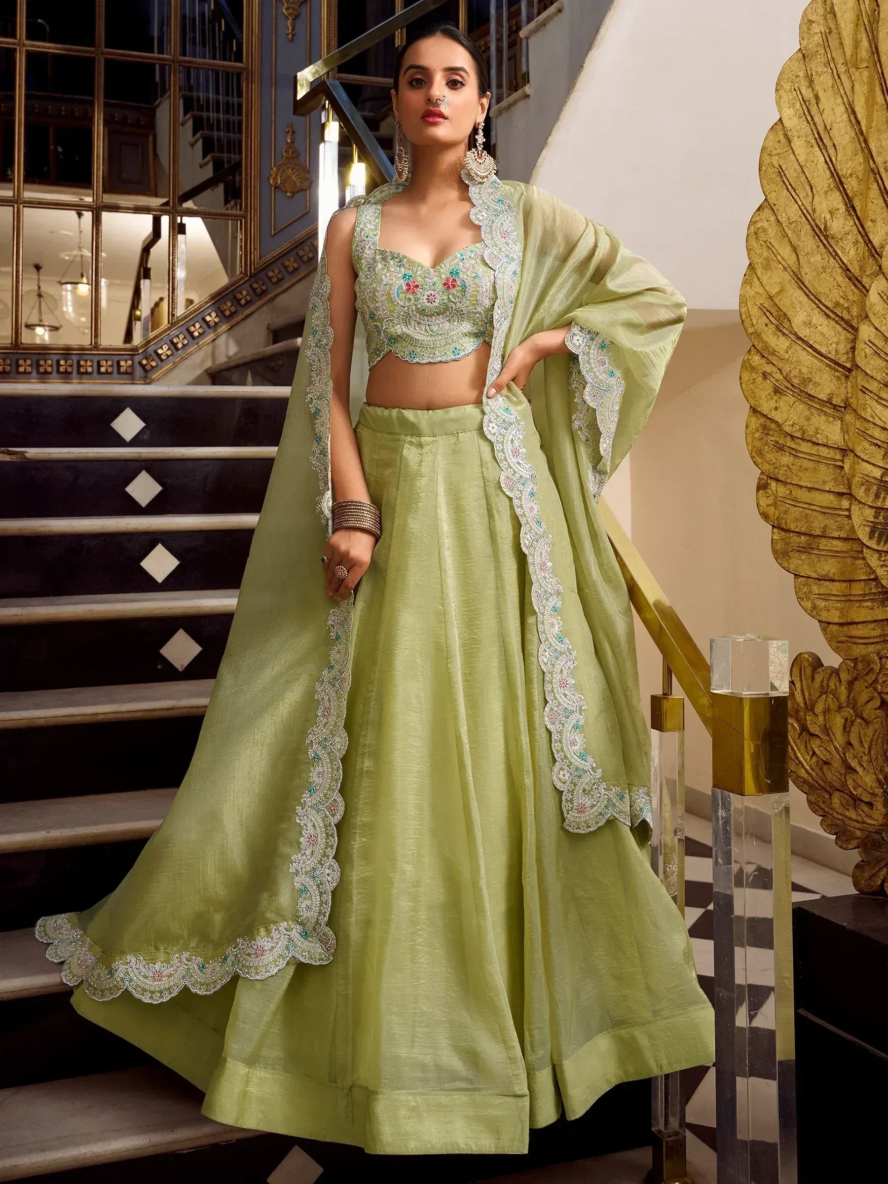 Light green embroidered lehenga choli with floral detailing, perfect for Indian ethnic wear occasions.