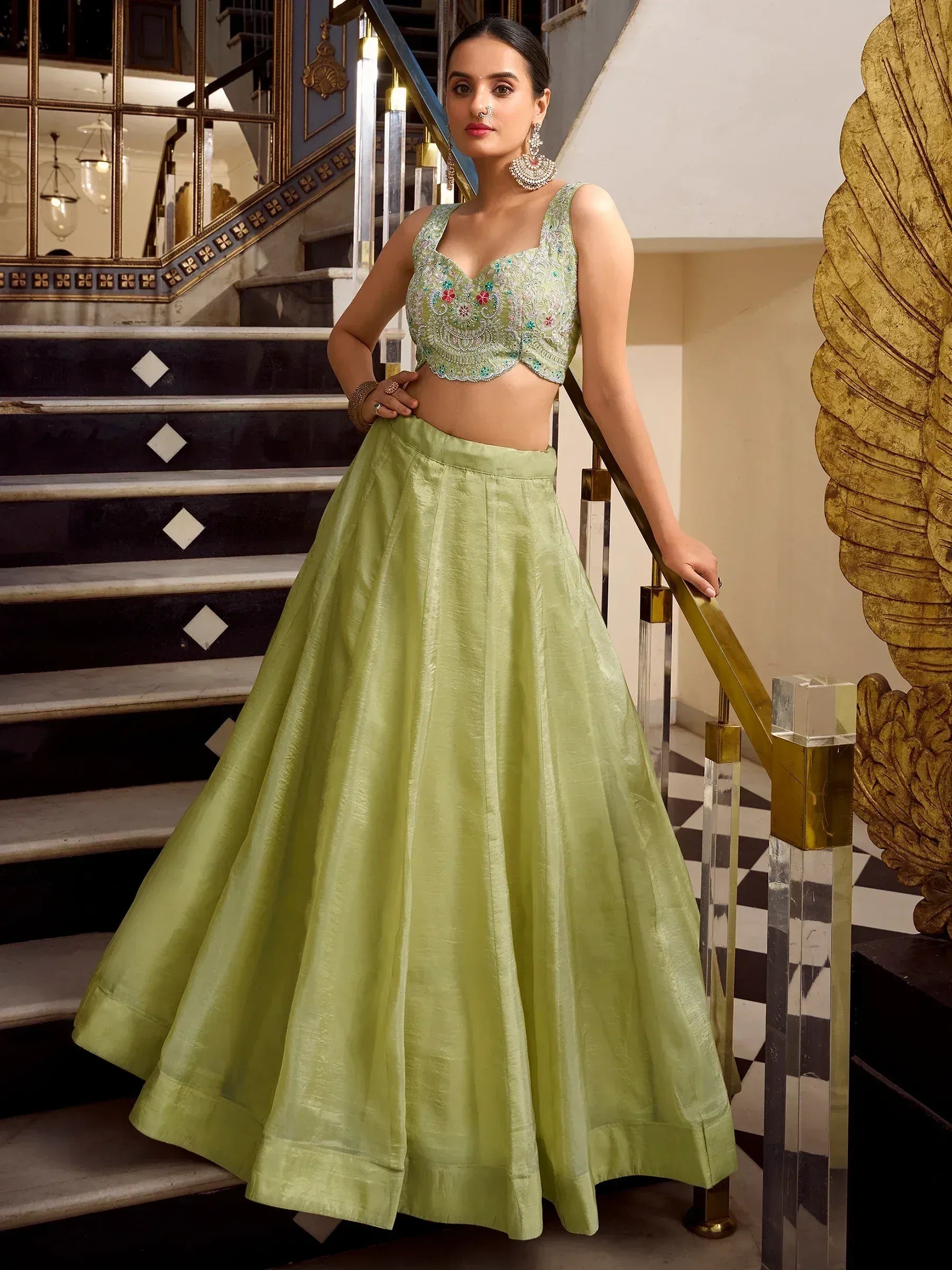 Light green embroidered lehenga choli with floral detailing, perfect for Indian ethnic occasions and weddings.