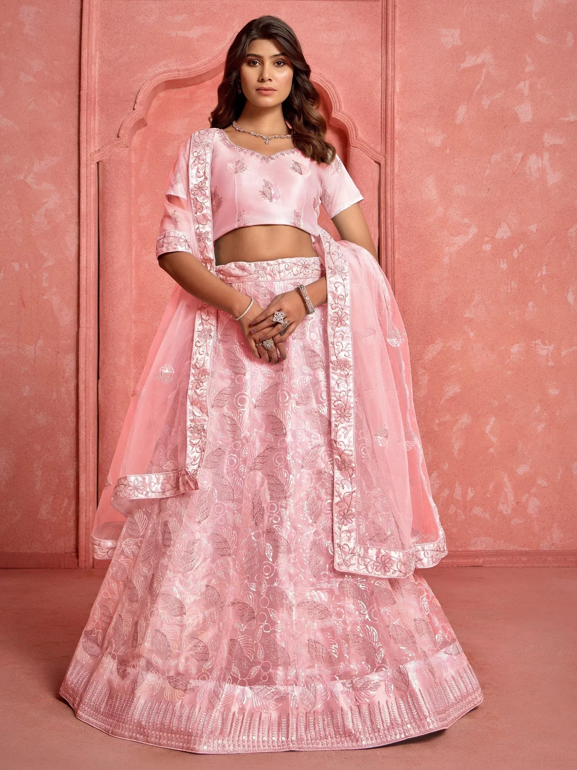 Pink embroidered lehenga choli with floral motifs, perfect for Indian weddings and festive occasions