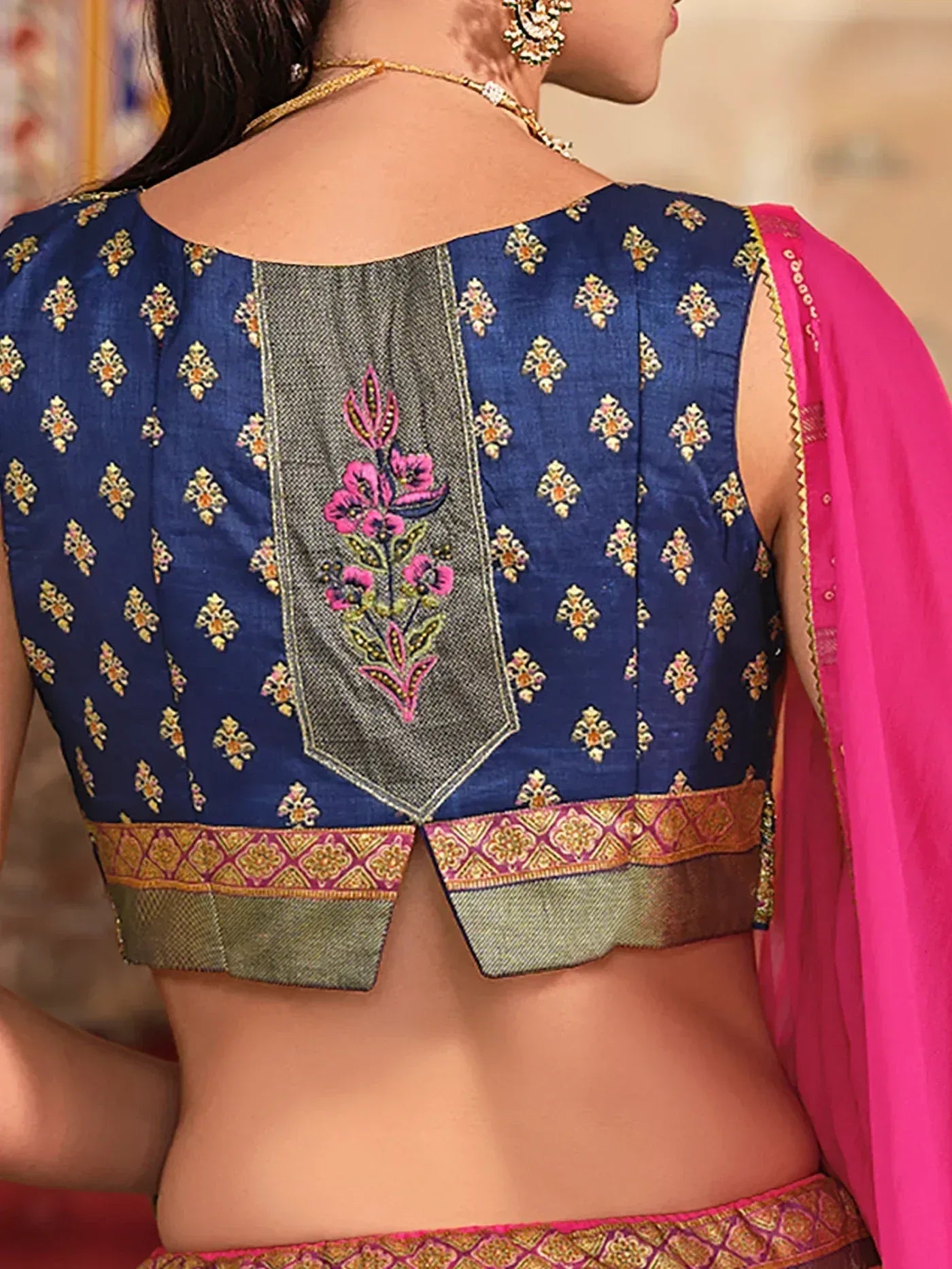 Blue embroidered blouse with pink floral back design, paired with pink dupatta, ethnic wear