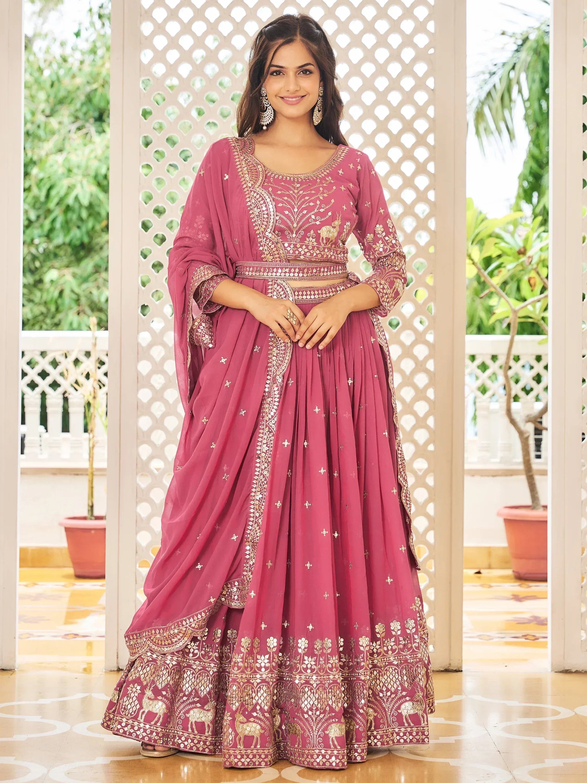 Pink embroidered lehenga choli with gold deer motifs, perfect for Indian ethnic wear occasions