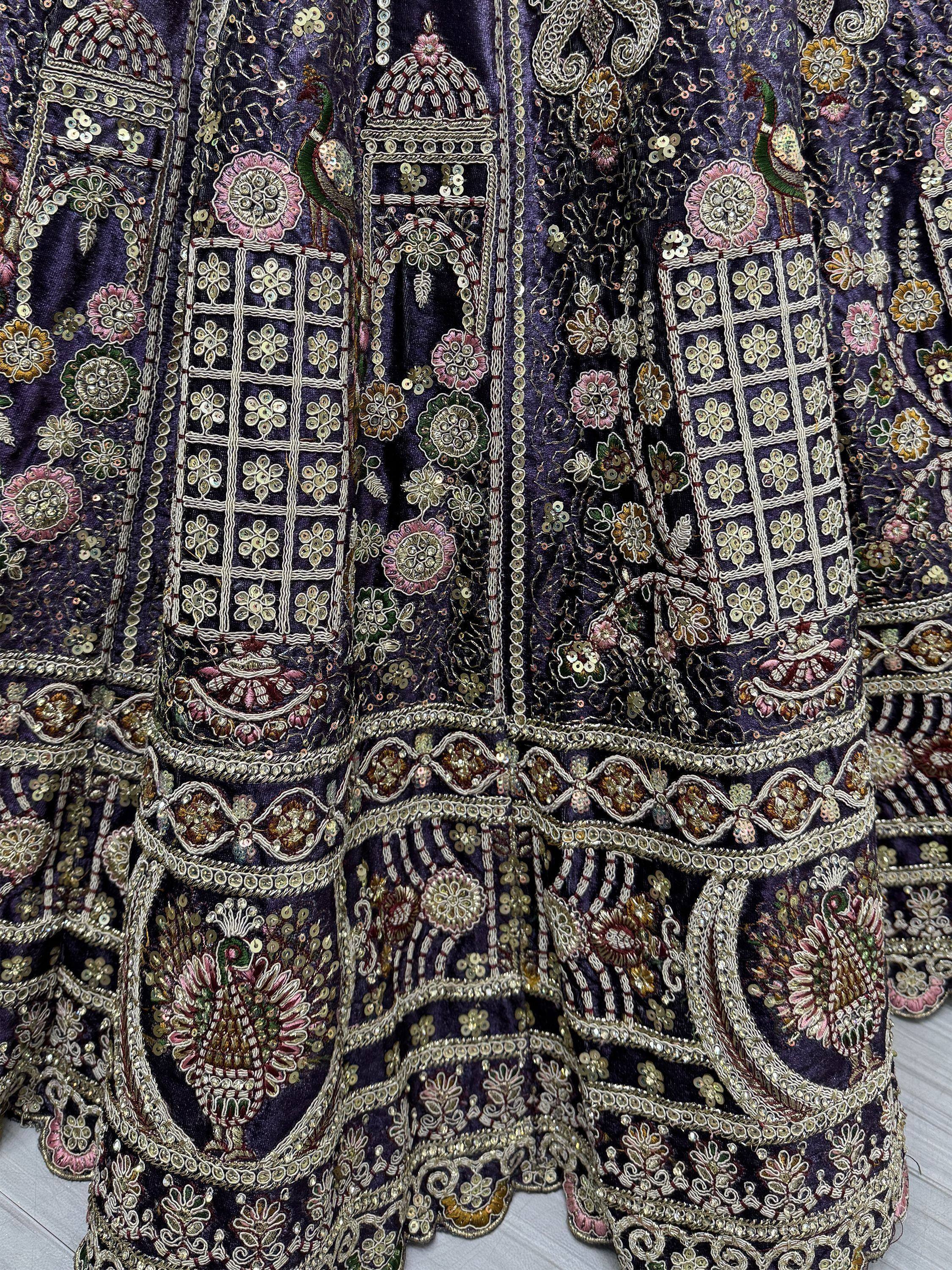 Purple ethnic wear with intricate peacock and floral embroidery, sequins, and zari work for festive occasions.