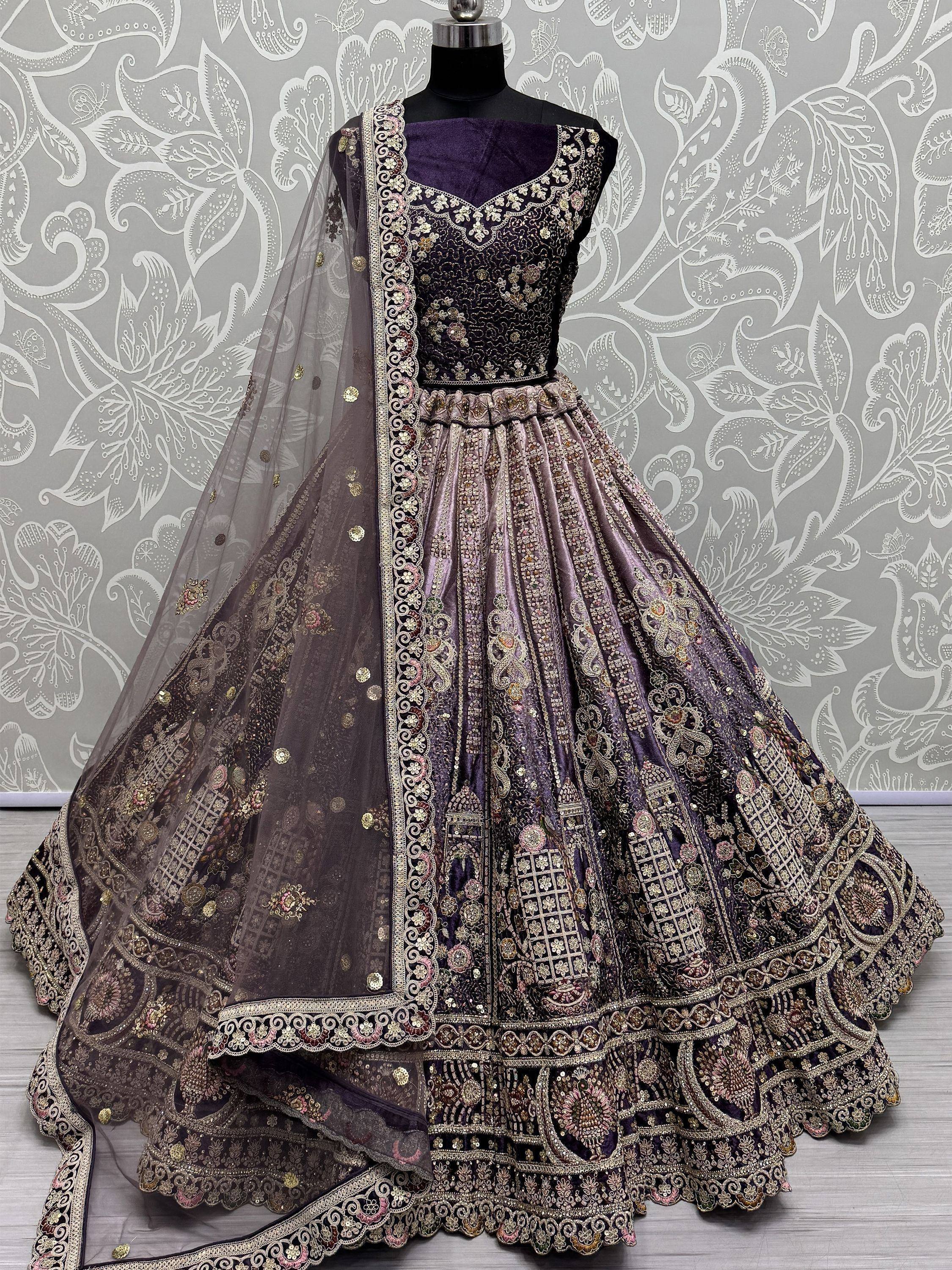Purple designer lehenga choli with heavy gold embroidery and matching dupatta, ideal for weddings and festive occasions.