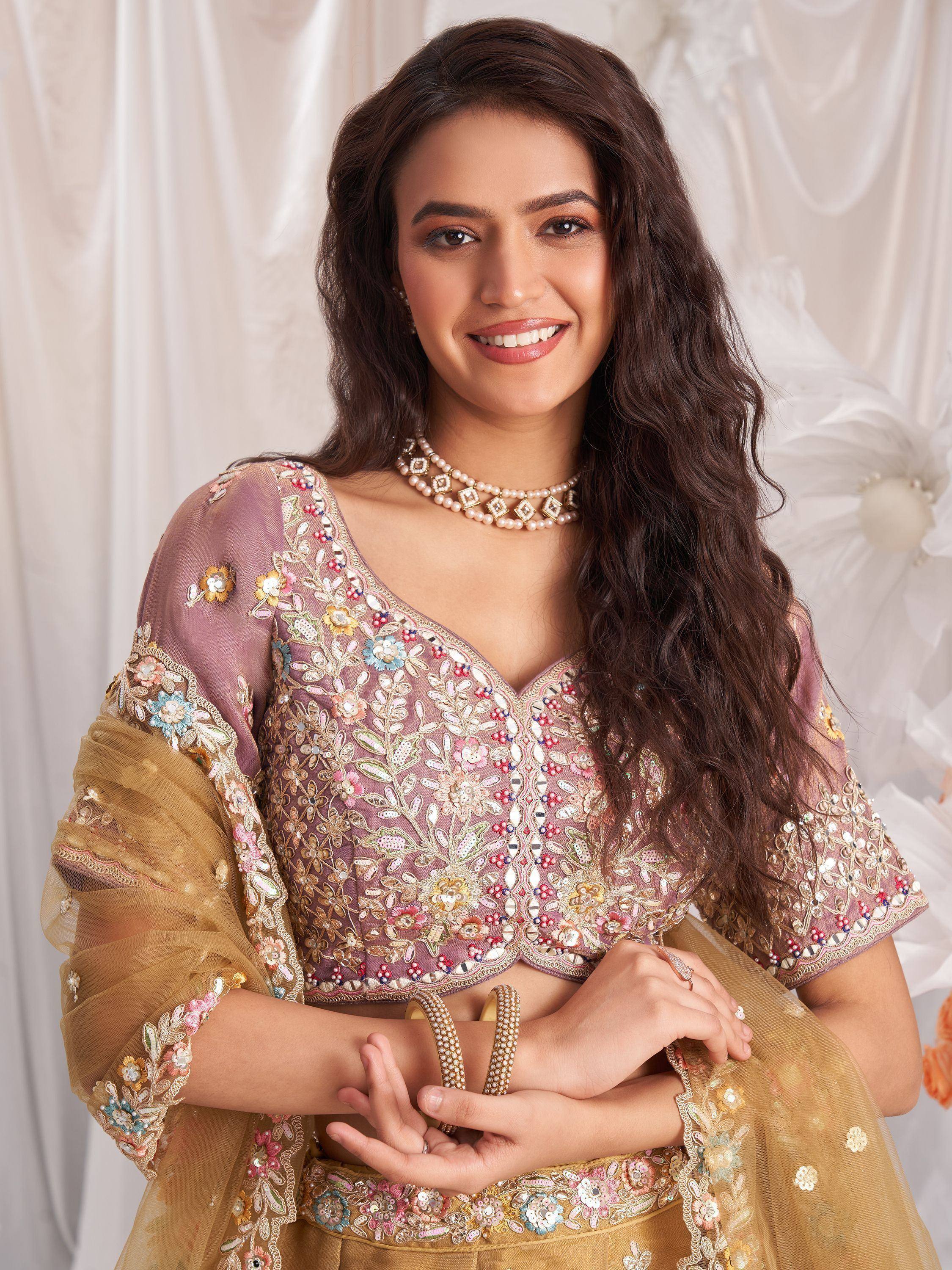 Woman in floral embroidered lehenga choli with sheer sleeves, perfect for Indian ethnic wear occasions