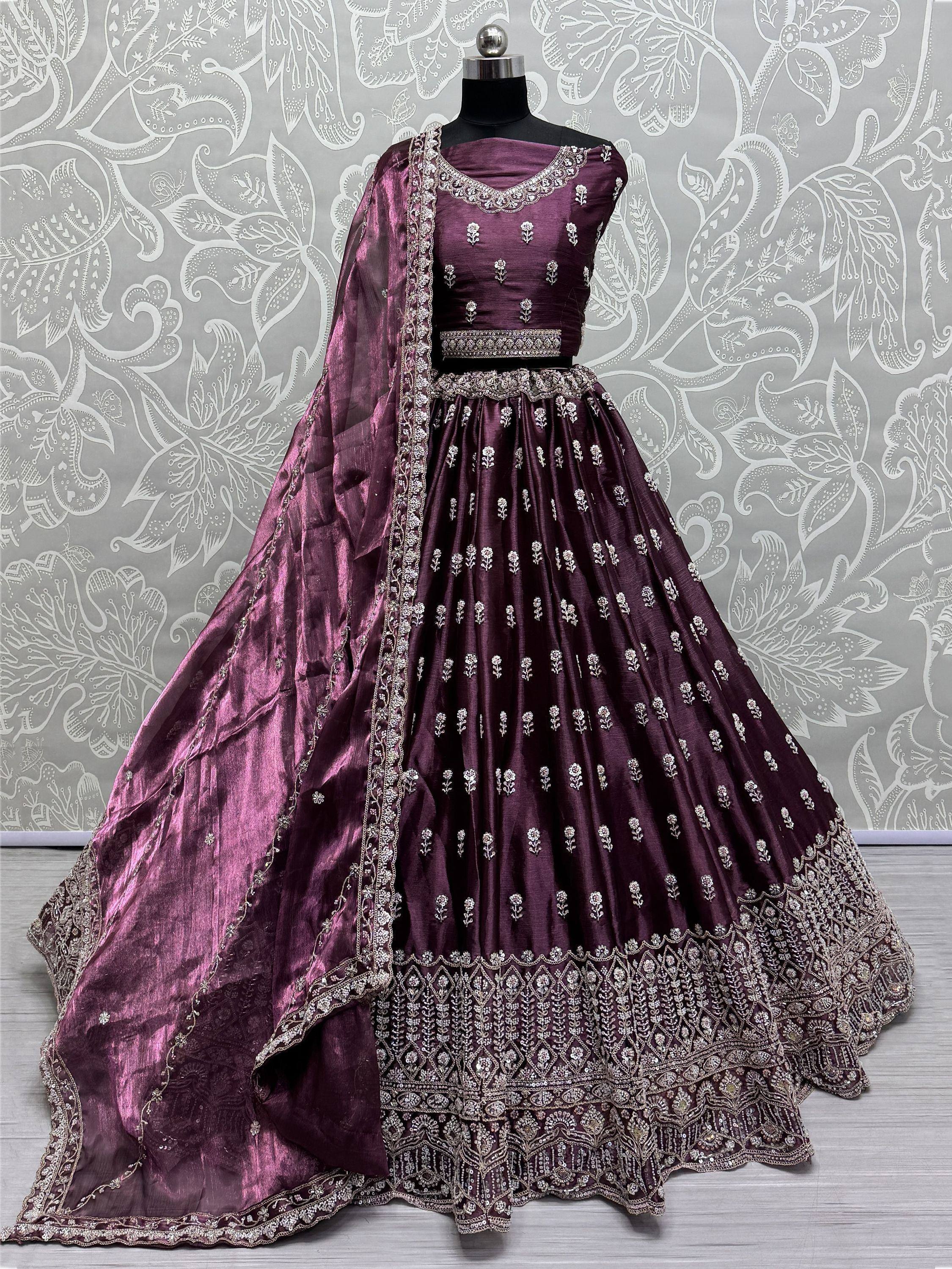 Elegant purple designer lehenga choli with silver embroidery and matching dupatta, perfect for Indian ethnic wear occasions.