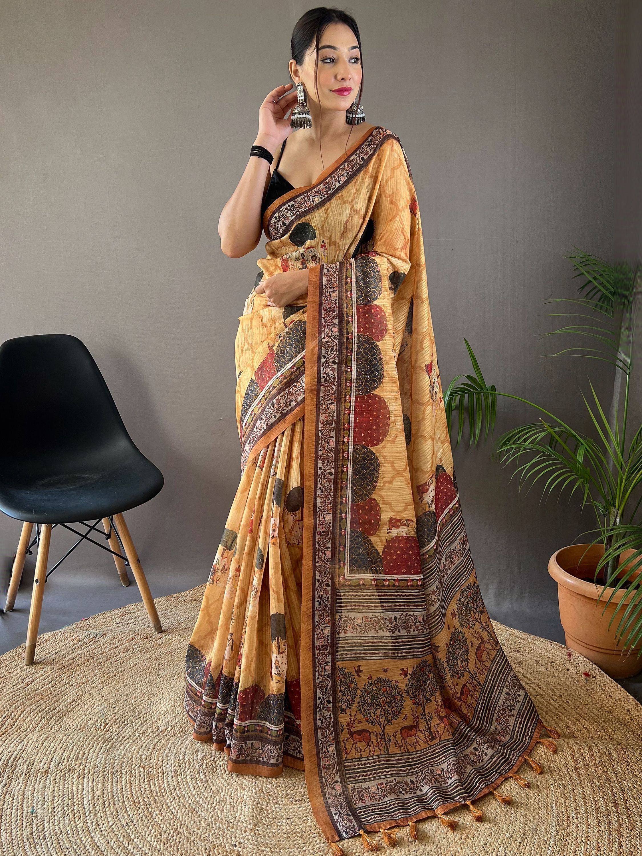 Woman in mustard yellow printed saree with ethnic motifs, perfect for Indian ethnic wear occasions