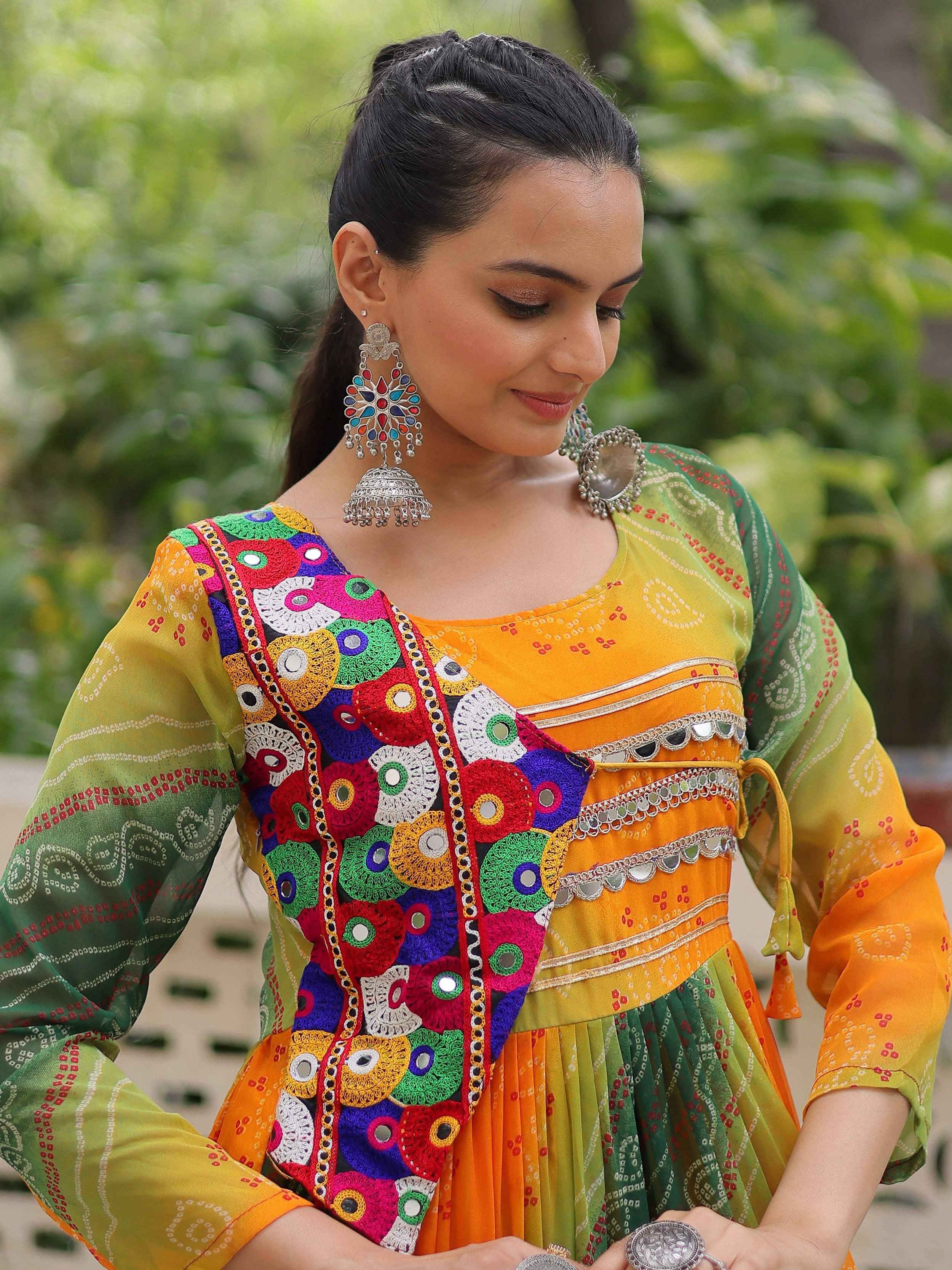 Vibrant Indian ethnic dress with mirror work, colorful embroidery, and traditional jewelry for festive occasions