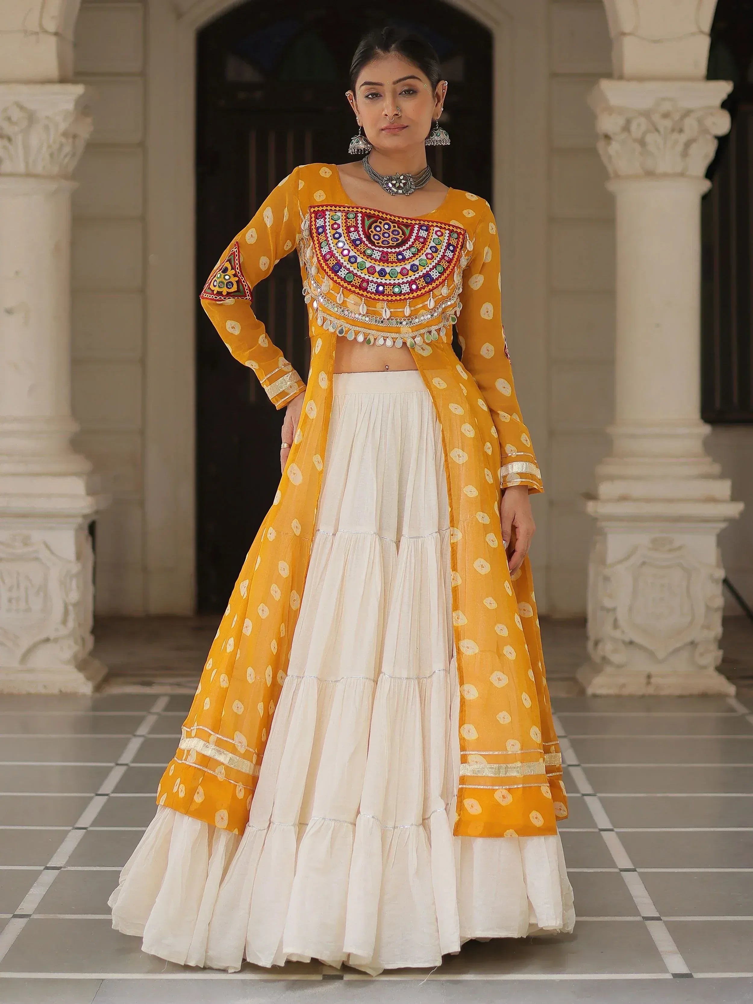 Yellow and white embroidered lehenga choli with mirror work, perfect for Indian ethnic wear occasions