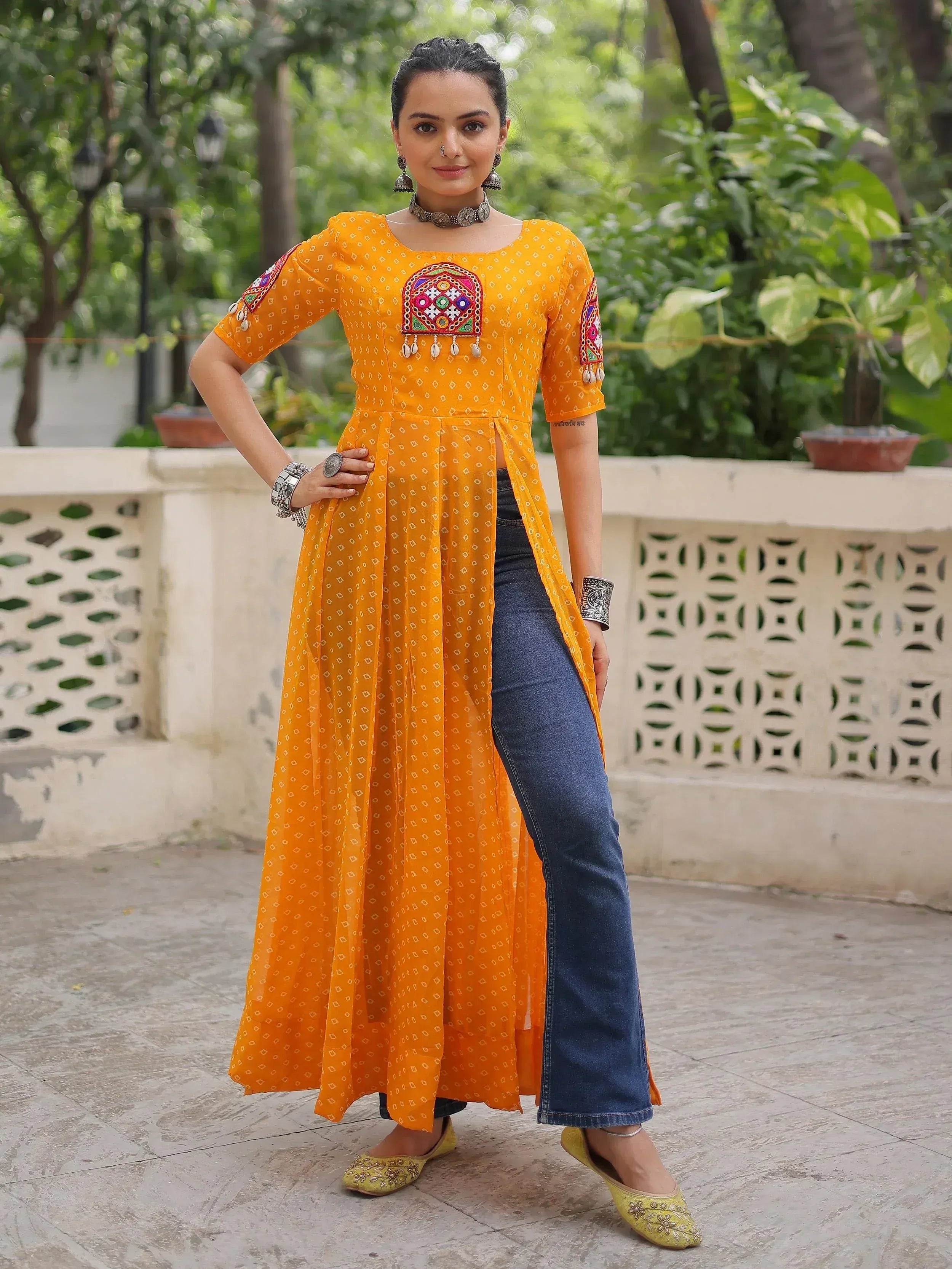 Yellow embroidered ethnic kurta with denim jeans, perfect for Indian festive wear