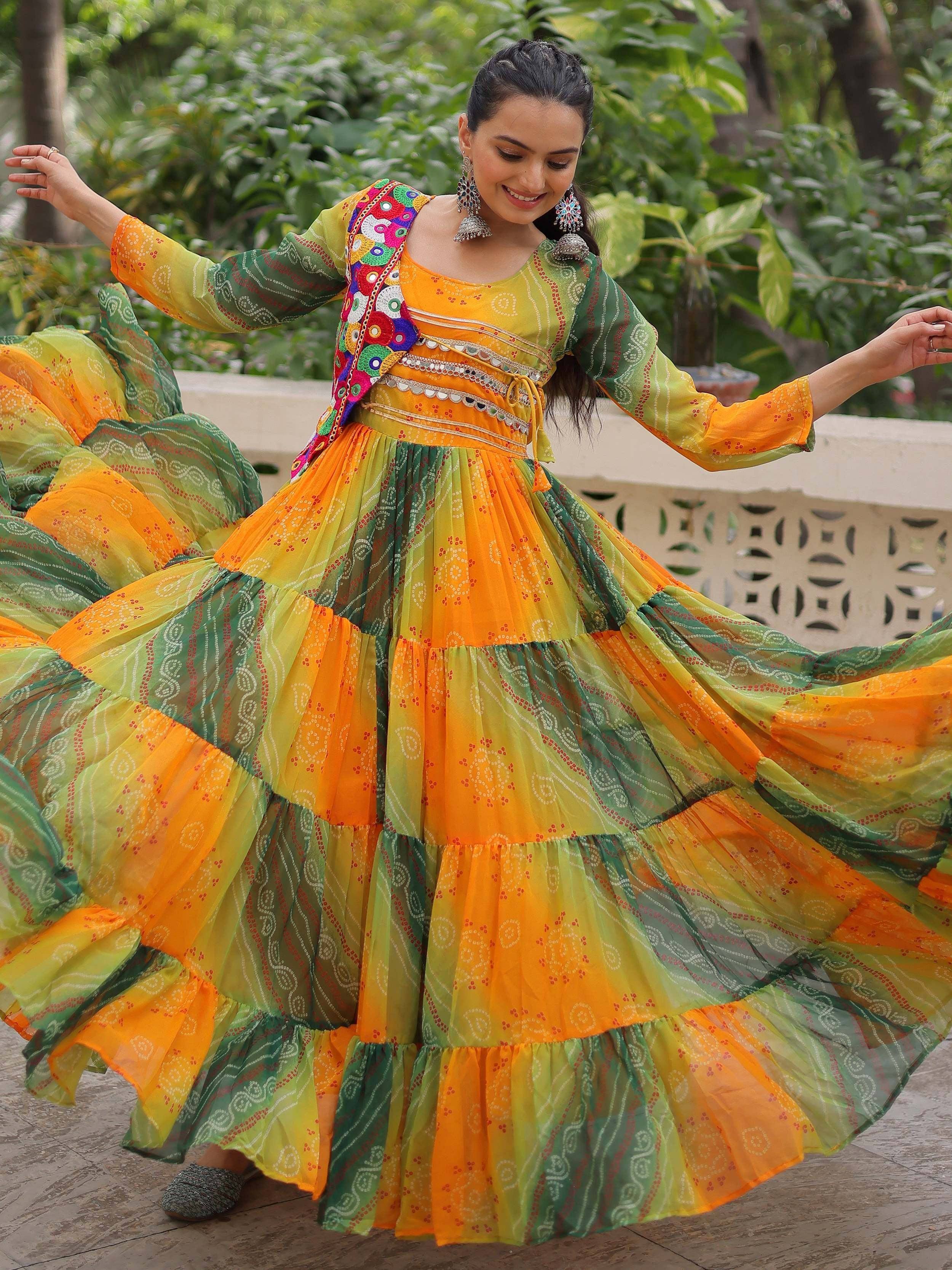 Vibrant orange and green ethnic gown with mirror work, perfect for festive occasions and traditional celebrations.